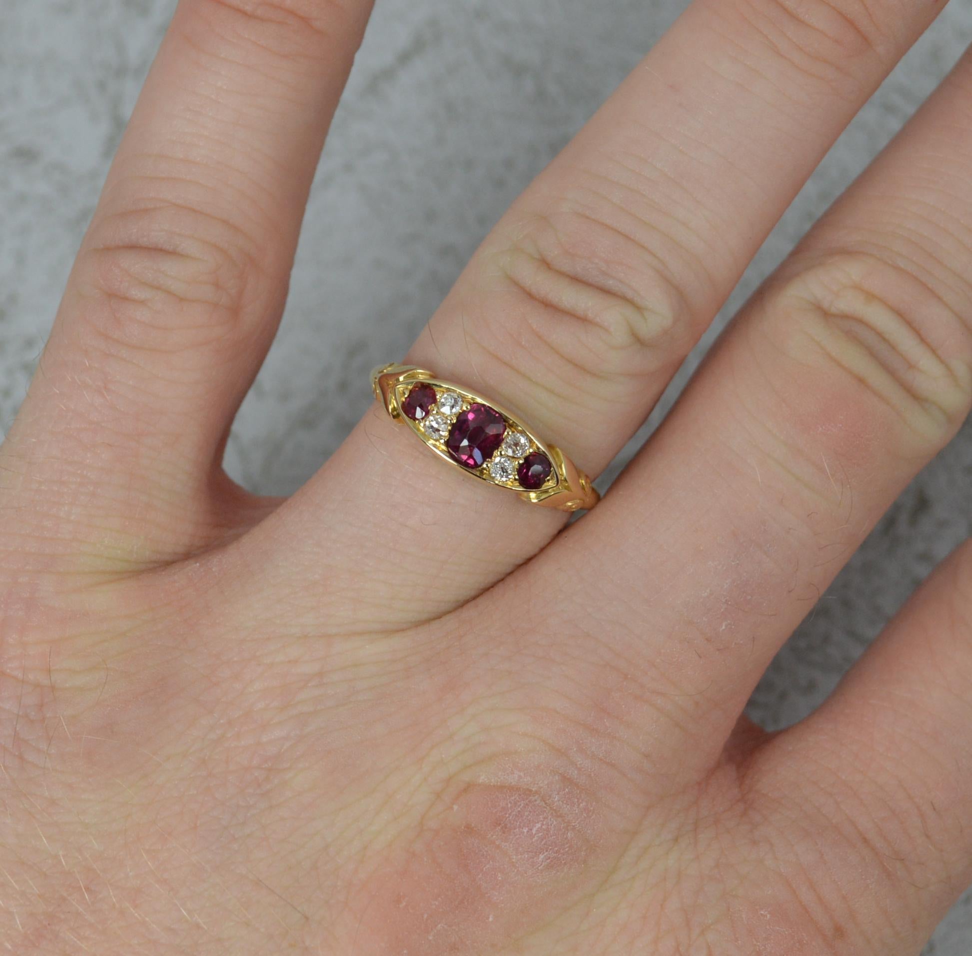 A superb Ruby and Diamond ring, circa 1900.
18 carat yellow gold example.
A boat shape cluster ring. Comprising of three very clean, deep, vivid red ruby stones with pairs of old cut diamonds in between each.
14.1mm x 5.7mm cluster head. Protruding
