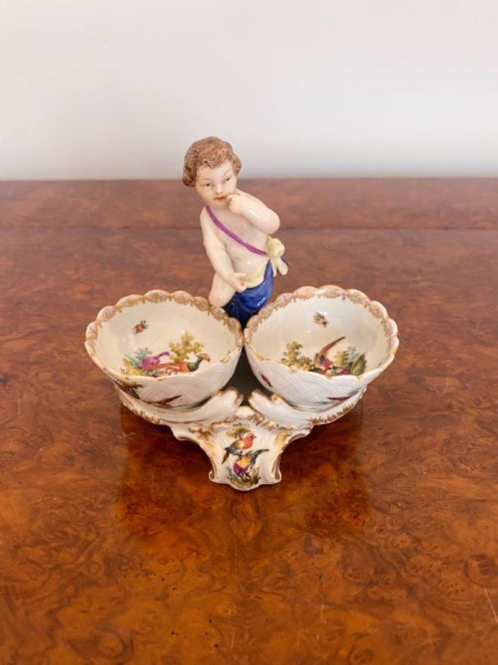 Quality Antique Victorian continental porcelain group having a cherub with two shaped bowls for salt and pepper on a shaped base with quality hand painted birds and scroll decoration in blue, red, green, yellow, white and gold colours.