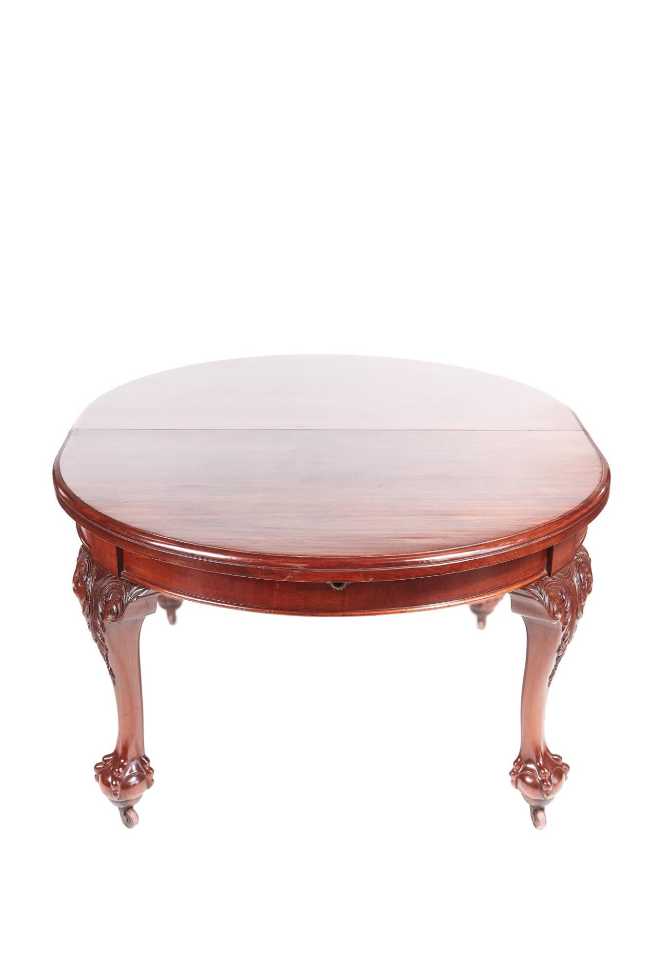 This is a quality Victorian antique mahogany extending dining table with a magnificent mahogany top having a moulded edge, two large extra leaves and features a winding mechanism with original handle. It stands on wonderful claw and ball legs with