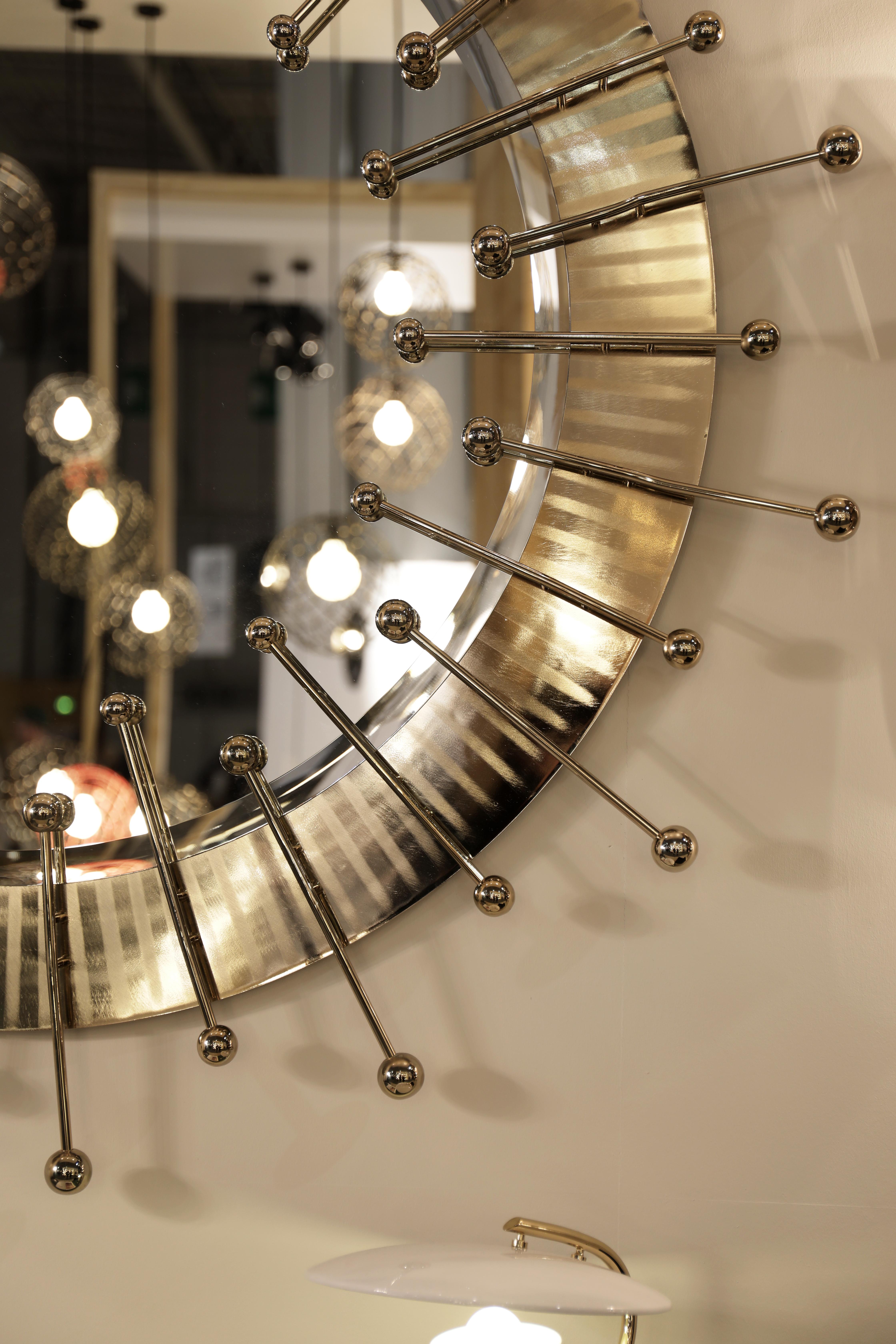 A contemporary descendant of mid-century modern style, the Quantum Mirror is not just a spot-on reflection of the atomic age design, it is a leap forward. A set of gold plated spheres arranged in a circular pattern create a stunning visual effect.