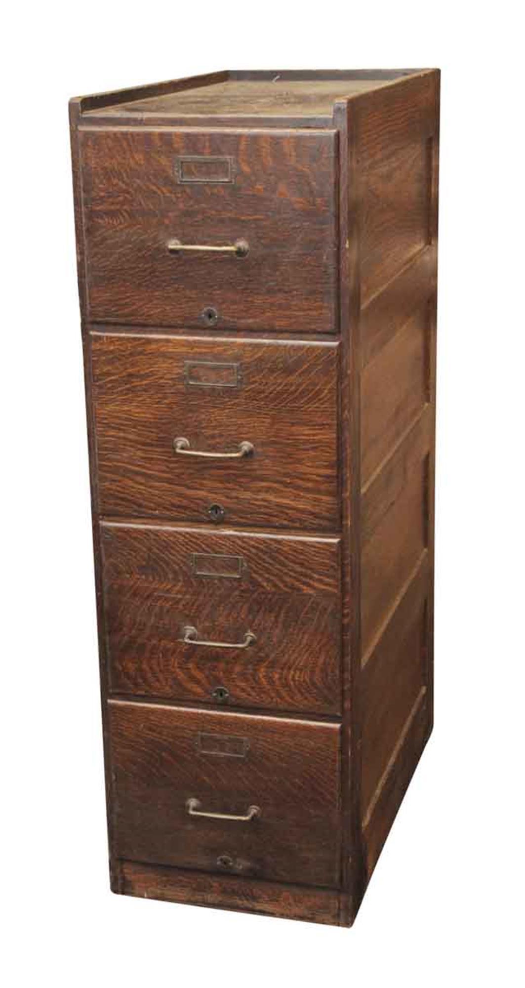 Quarter sawn oak file cabinet with recessed panels on both sides and letter sized drawers that go in and out freely, 1920s. This file cabinet has all original hardware and original finish. In excellent overall condition. This can be seen at our 302