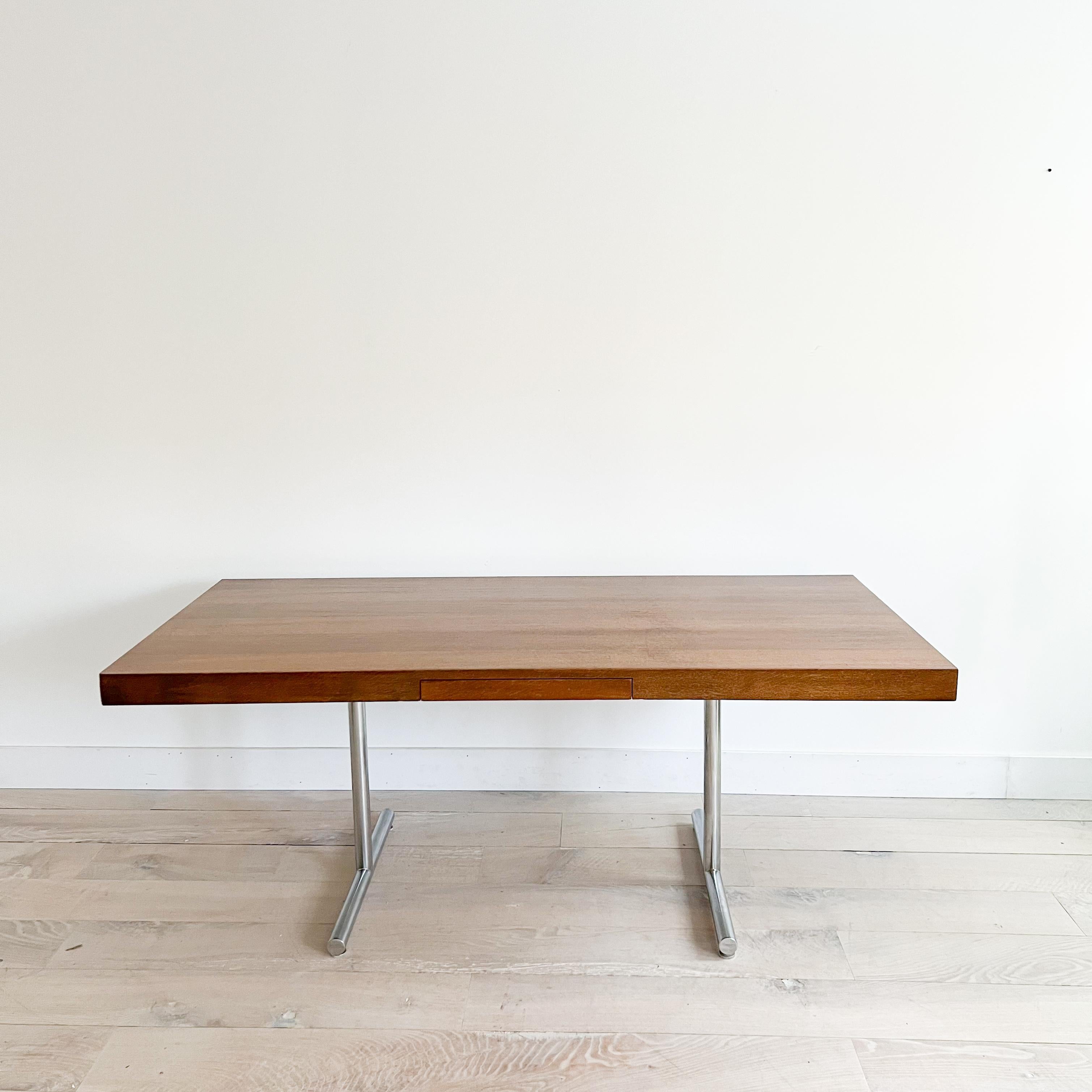 Stunning mid century modern quarter sawn oak desk with  chrome base by Hans Eichenberger for Stendig. Stamped “Stendig” underneath. The top has been sanded and restored. Hidden single drawer. Some light scuffing/scratching from age appropriate wear. 