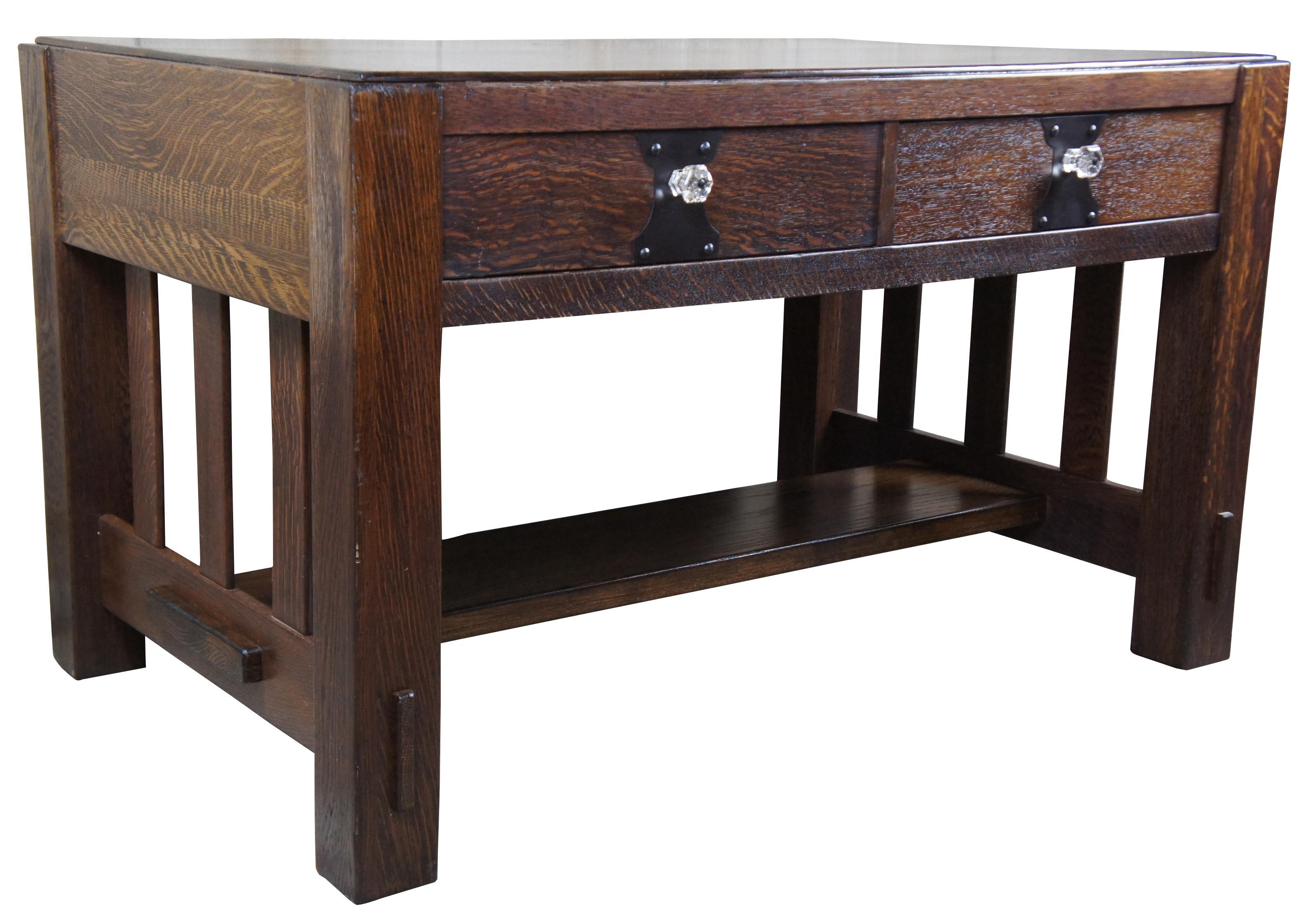 Vintage quartersawn oak library writing desk or table. Features two long dovetailed drawers, iron hardware and glass knobs. Made during the latter half of the 20th century.
  