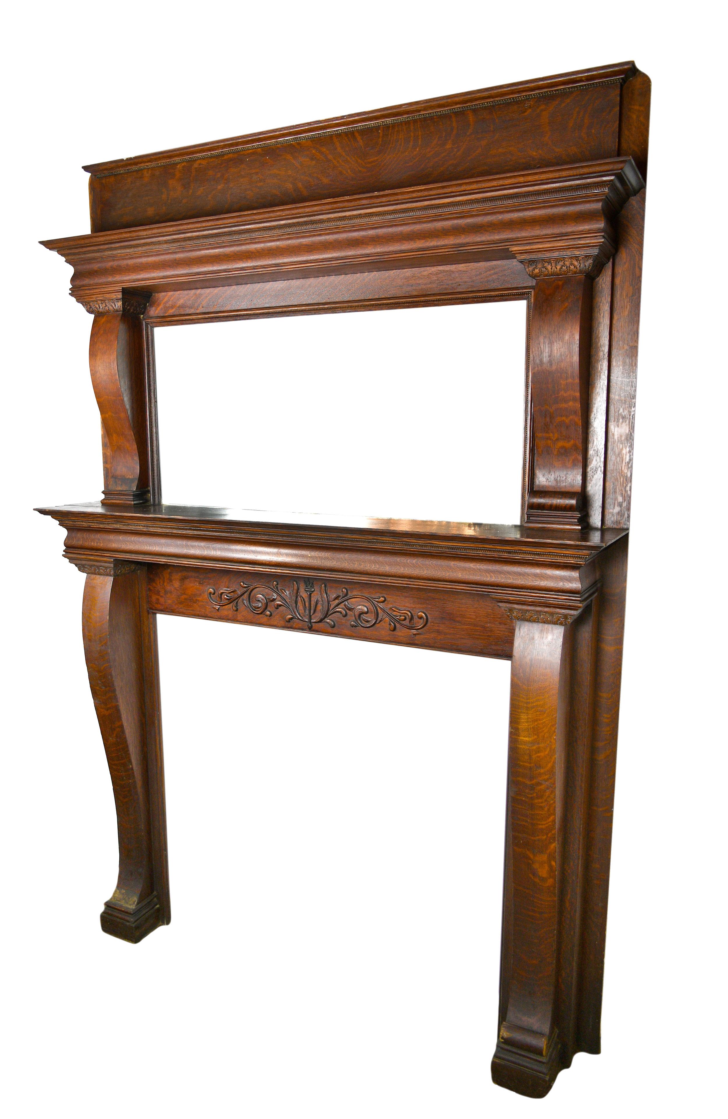 This lovingly crafted mantel is made of handsome quarter sawn oak and features a large glass mirror and two curved corbels. This mantel features a finely detailed Empire/ colonial design style.

Dimensions: 
Overall 60” wide x 87 5/8” tall x