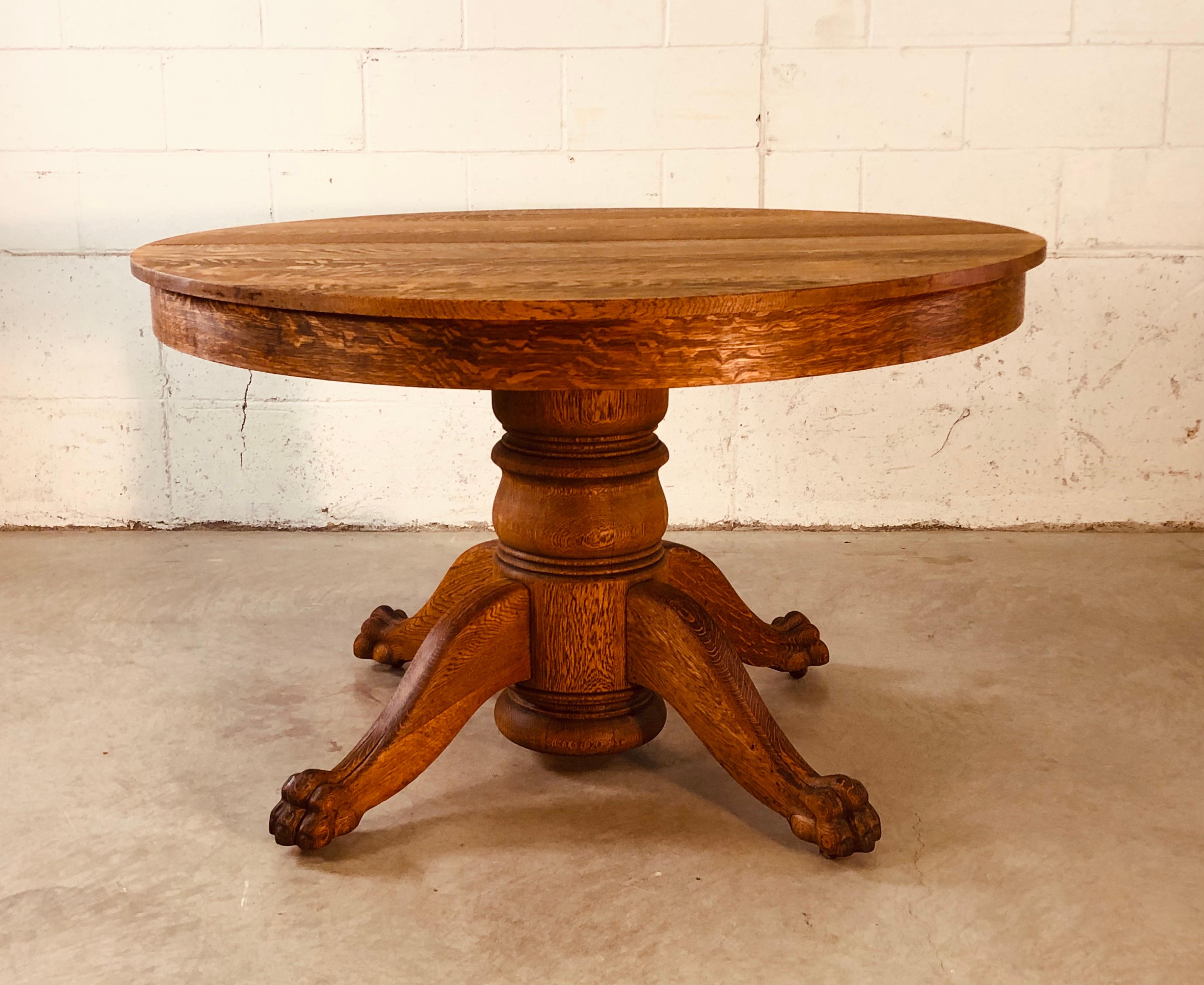 Antique quartersawn oak claw foot pedestal round table. Beautiful claw feet that are large and well defined. The table has a great oak grain that comes through with the recent restoration. No additonal boards. No marks.
