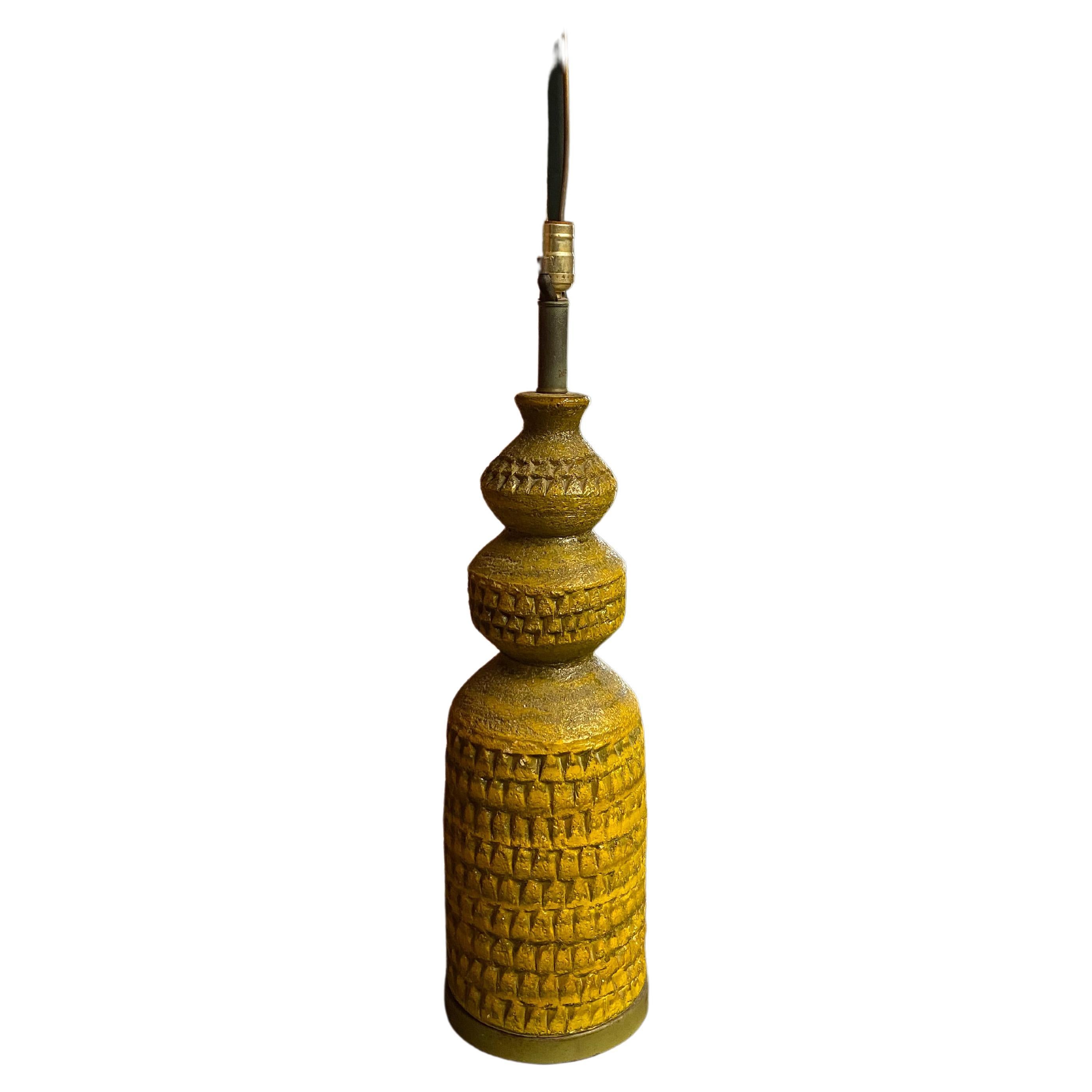 All the great attributes to a good brutalist type table lamp: color, texture and form. The plaster body bares all the highly significant modeling and color variations that please the eye. A tall and striking form that is signed with impressed