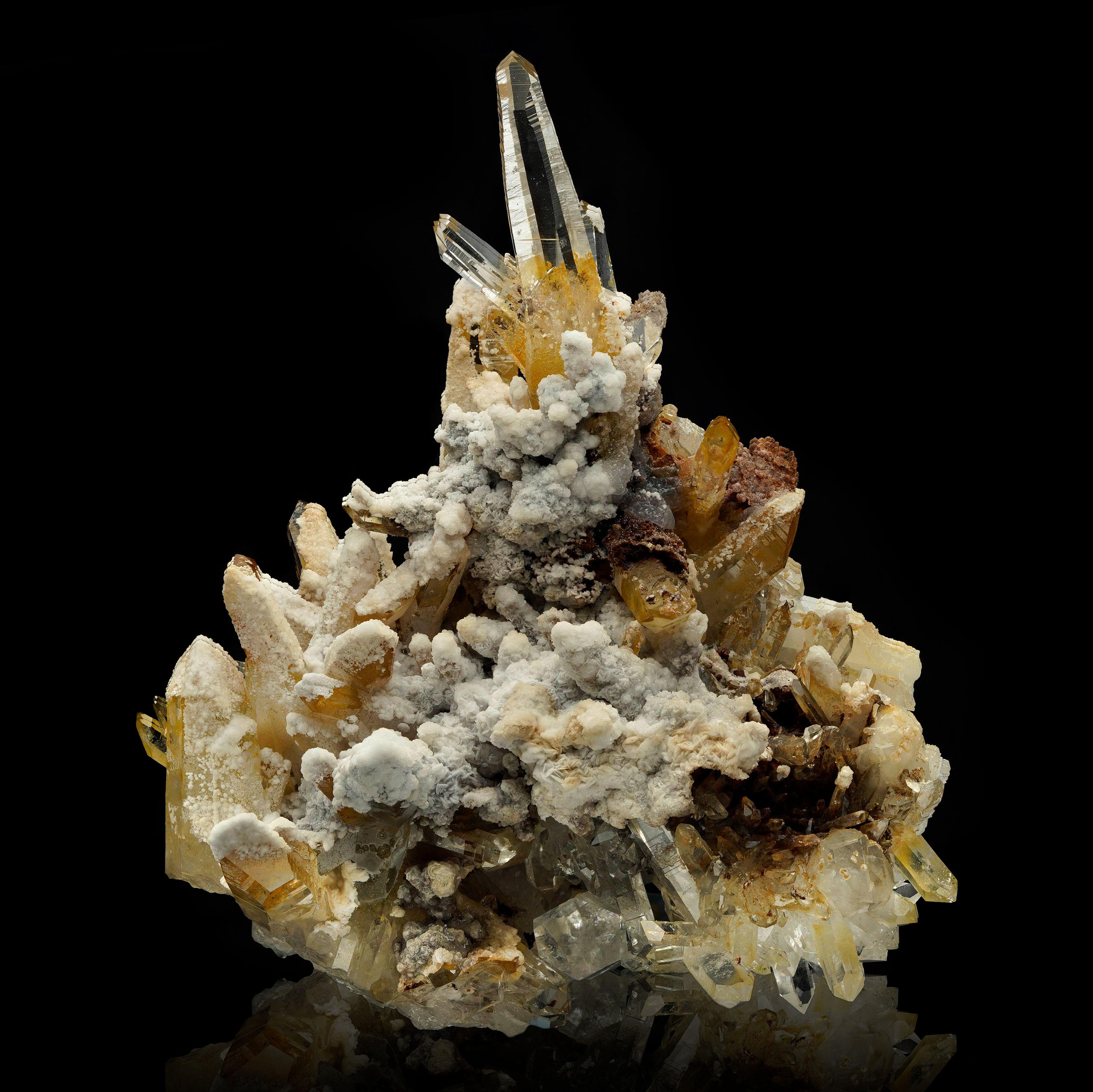 This extraordinary Quartz and Aragonite specimen from Colombia is a true masterpiece of natural artistry. Featuring strikingly clear quartz points intertwined with earthy aragonite formations, this piece creates a captivating gallery of contrast and