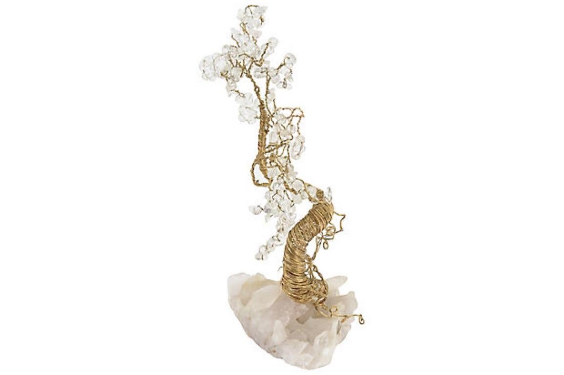 Organic tree sculpture made of goldtone wire and crystals on a quartz base.
 