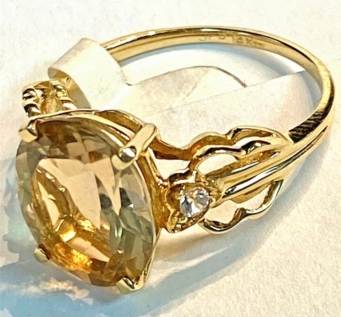 14k yellow smoky yellow Quartz and Diamond, 3.23 Grams TW. The dimensions are approximately 12 mm x 8mm. Approximately 3 carats. Marked 14k. Approximate size 7.0.
