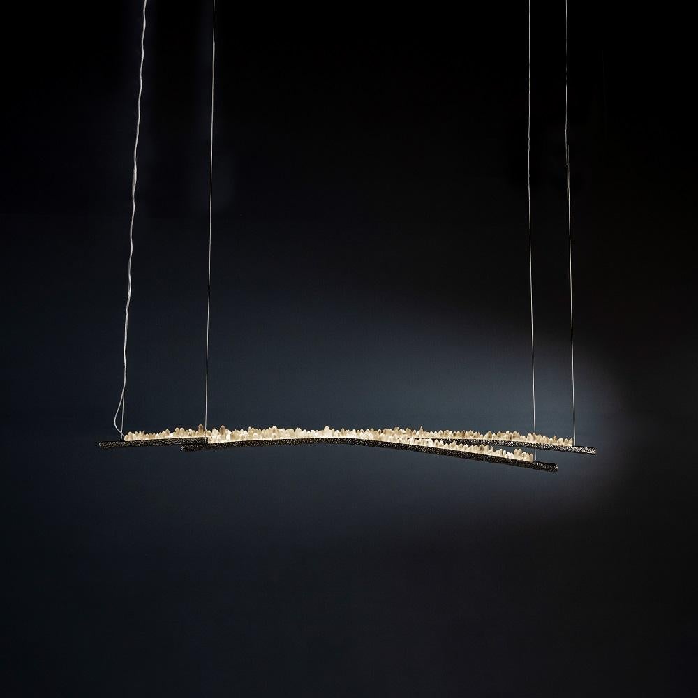 Quartz pendant light I by AVer
Dimensions: W 180 x D 40 x H 12 cm
Materials: Natural rocks, high-quality cut crystals, jewelry chains, hand-blown glass, other.
Also available: matte black, rustic silver, oxidized graphite, and rustic bronze.

A