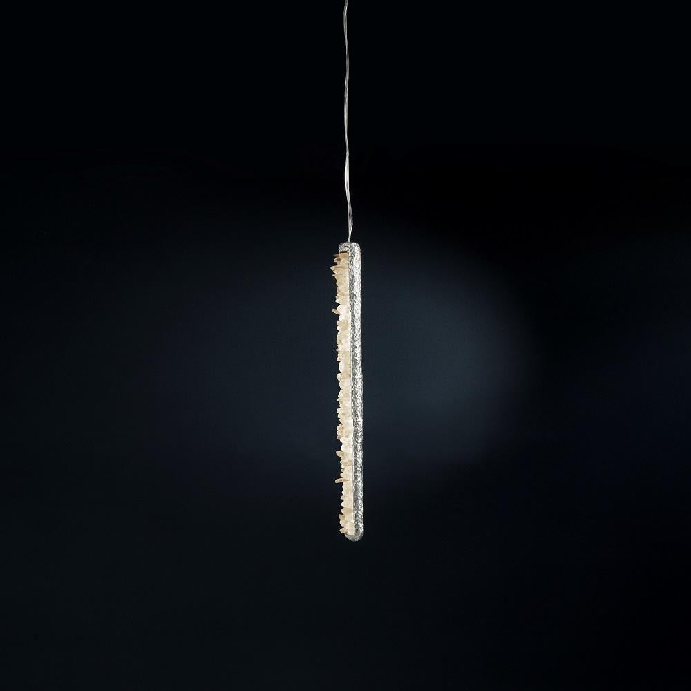 Quartz pendant light V by Aver
Dimensions: W 7 x D 5 x H 65 cm
Materials: Natural rocks, high-quality cut crystals, jewelry chains, hand-blown glass, other.
Also Available: Matte Black, Rustic Silver, Oxidized Graphite, and Rustic Bronze.

A series