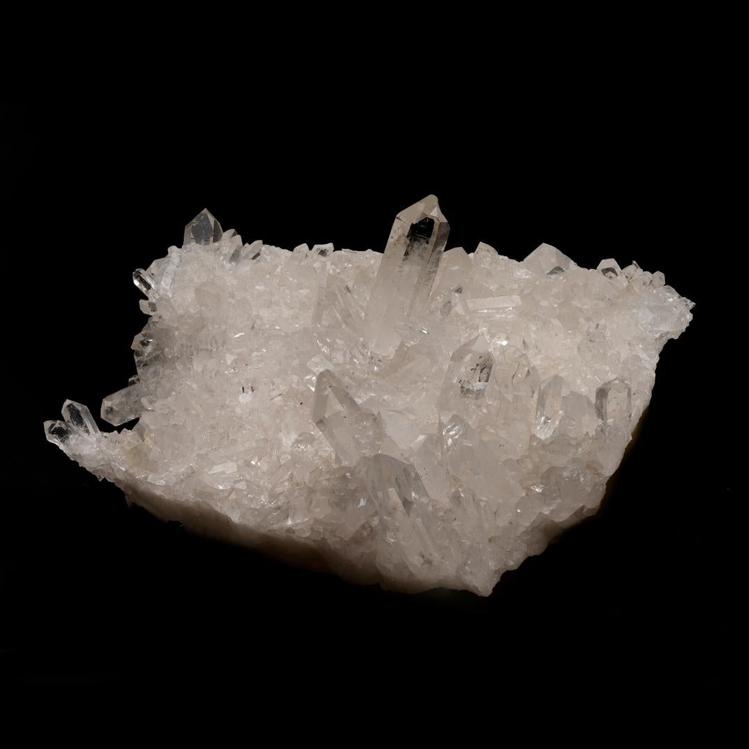 This quartz cluster with wonderful clarity is abundant with beautiful, glassy terminations of varying sizes and comes out of Arkansas, a location famous for the quality and clarity of its quartz, making this a collector's piece with a pedigree as