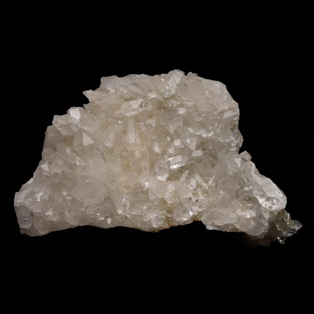 This cabinet size quartz cluster with wonderful clarity is abundant with beautiful moderately sized terminations - many containing rainbows - and comes out of Arkansas, a location famous for the quality and clarity of its quartz, making this a