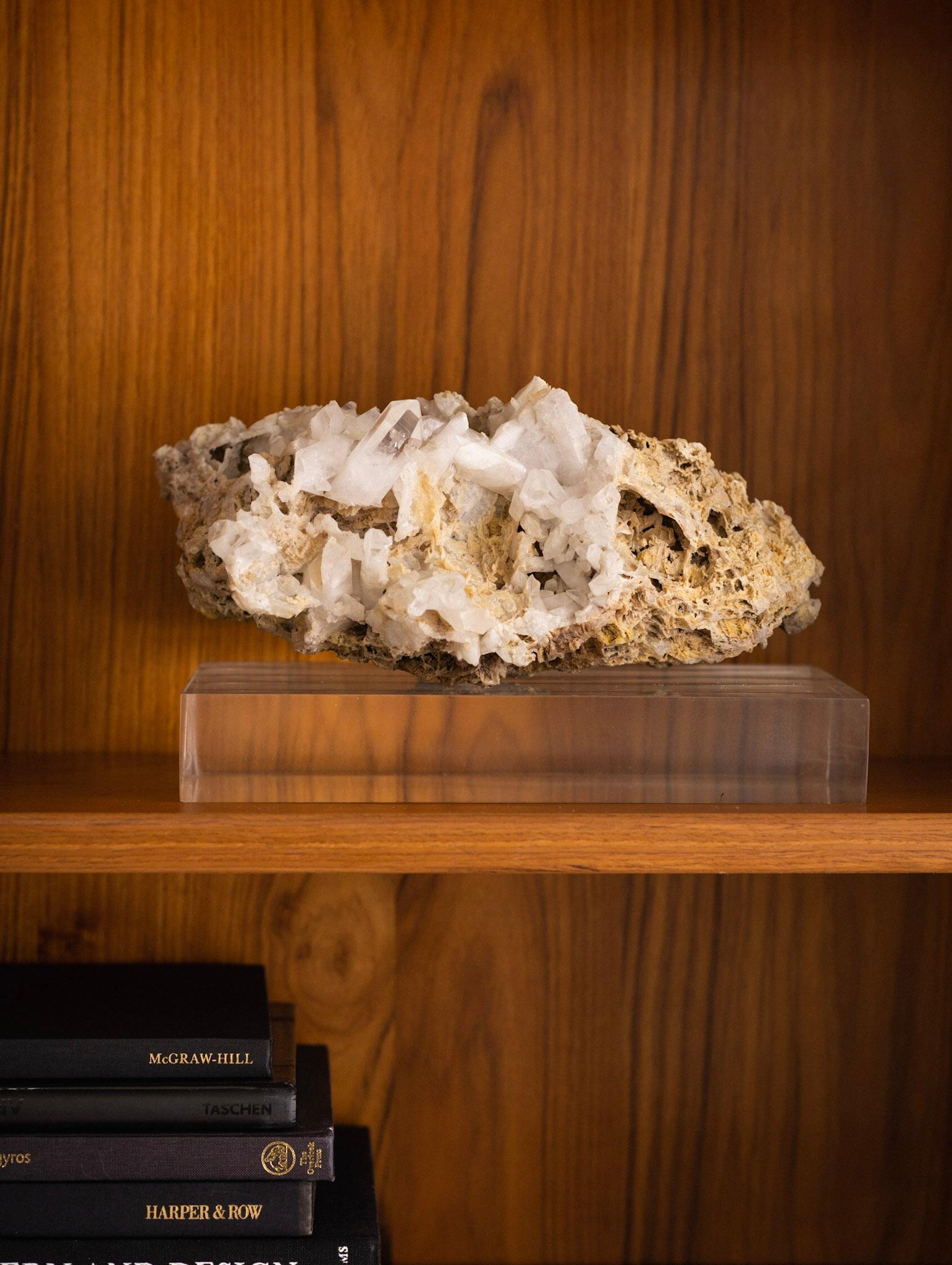 Quartz crystal cluster specimen on vintage lucite base. Crystal simply rest upon lucite plinth. Lucite base measures: 12” W X 8” D X 2” H.