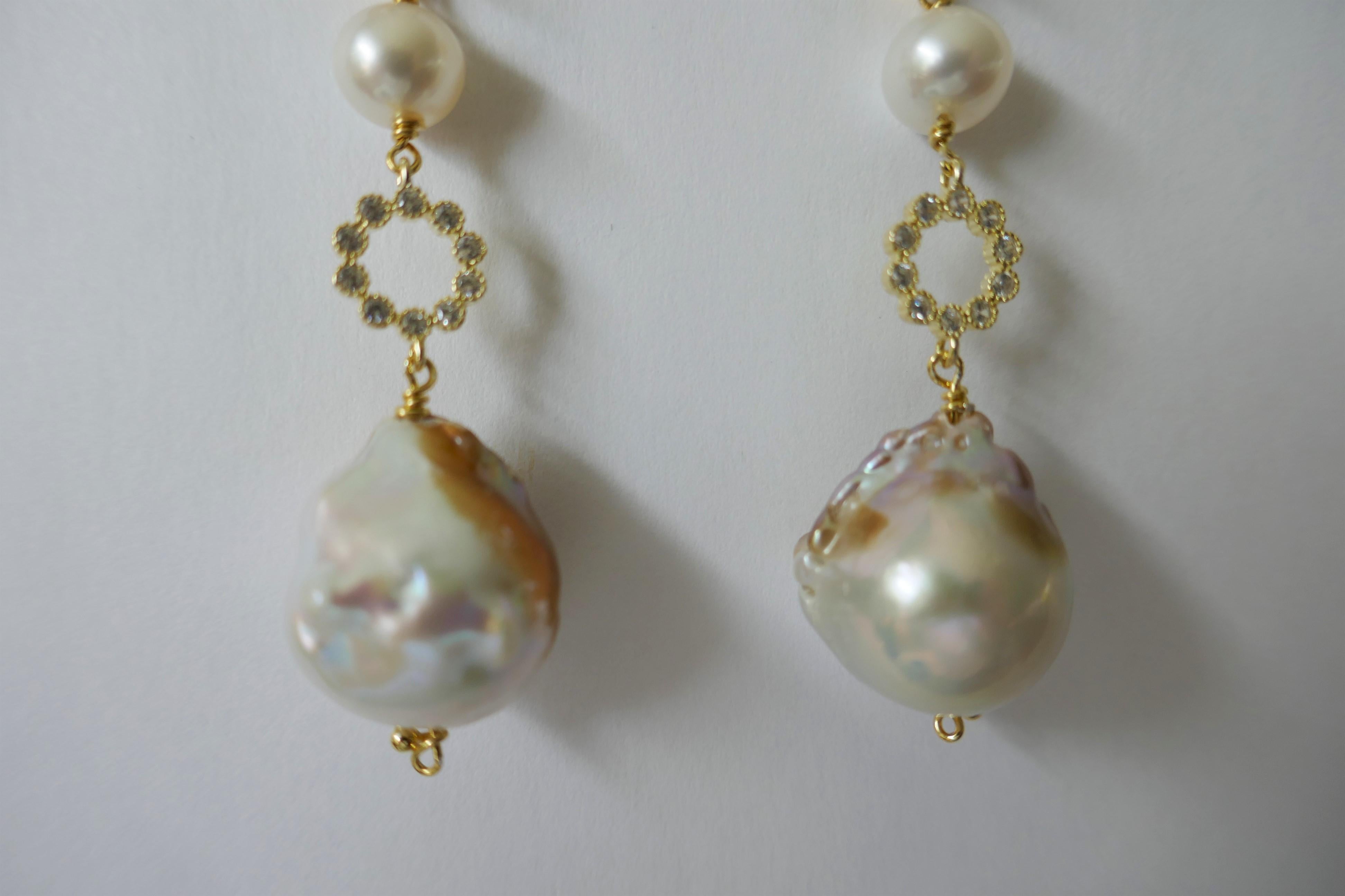 The earrings have a 10x10mm white topaz on 14k plated 925 silver, an 8mm white cultured pearl,  a 9mm cubic zirconia bead and  14mm baroque cultured pearls. These earrings can be dressed up or down.  The large backs are gold filled.  The earrings