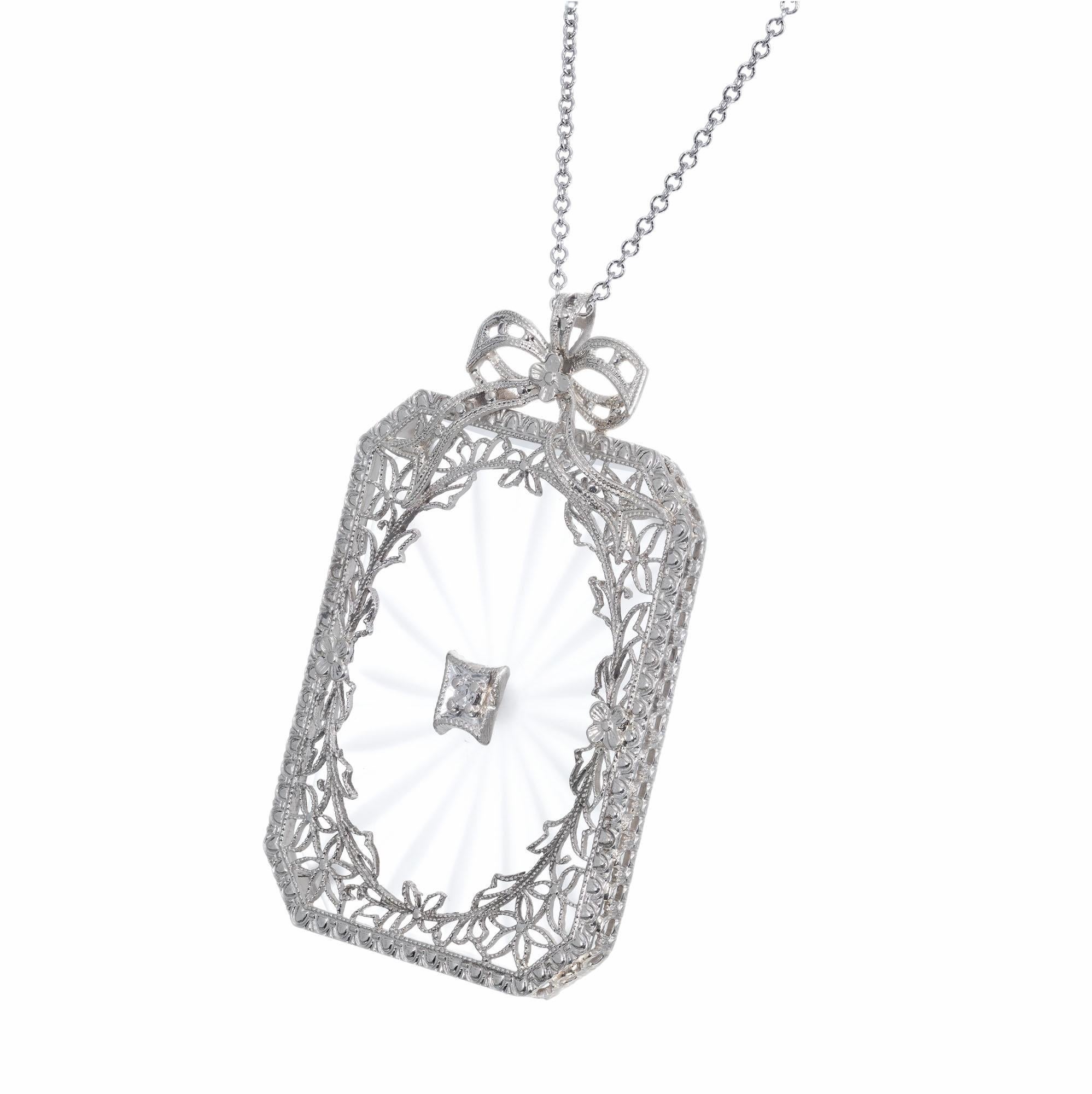 Quartz and diamond pendant necklace. Rectangle quartz with an old mine diamond accent set in a filigree open work 14k white gold design, with a 14k white gold chain. 

1 rectangle quartz
1 old mine diamond I, SI approx. .3cts
14k white gold 
8.9