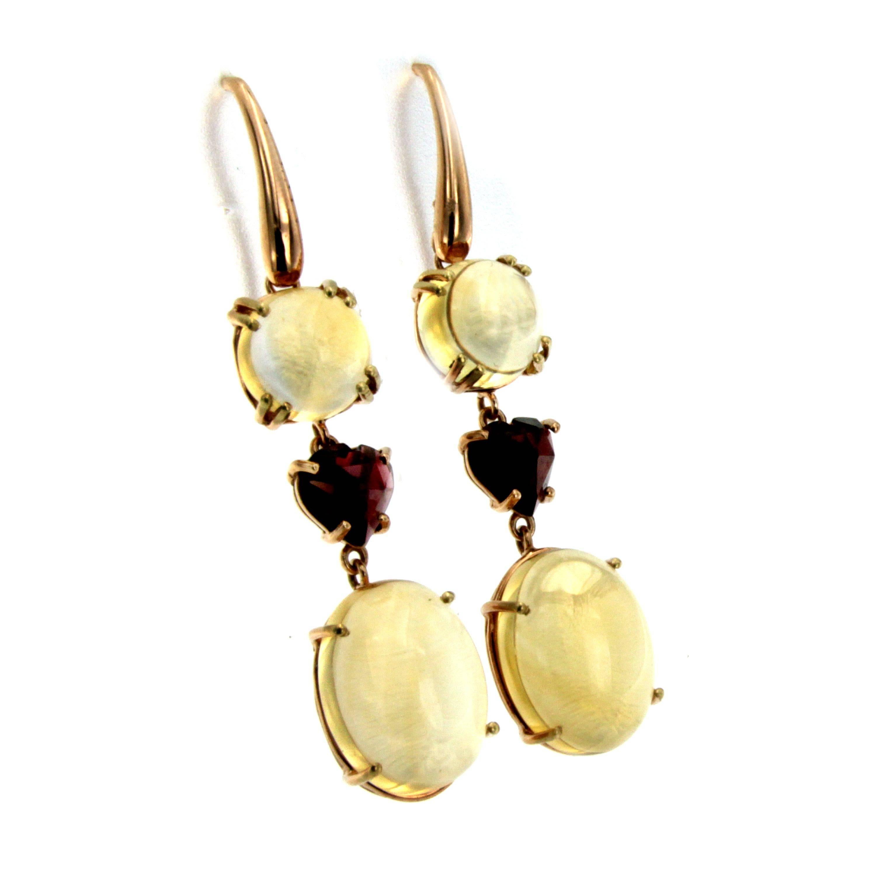 These Beautiful and unusual 18k white rose gold earrings feature at the bottom 2 large teardrop oval natural Citrine Quartz, connected by open links set with 2 Heart cut Garnet and up two cabochon of Citrine Quartz.

CONDITION: Brand new
METAL: 18k
