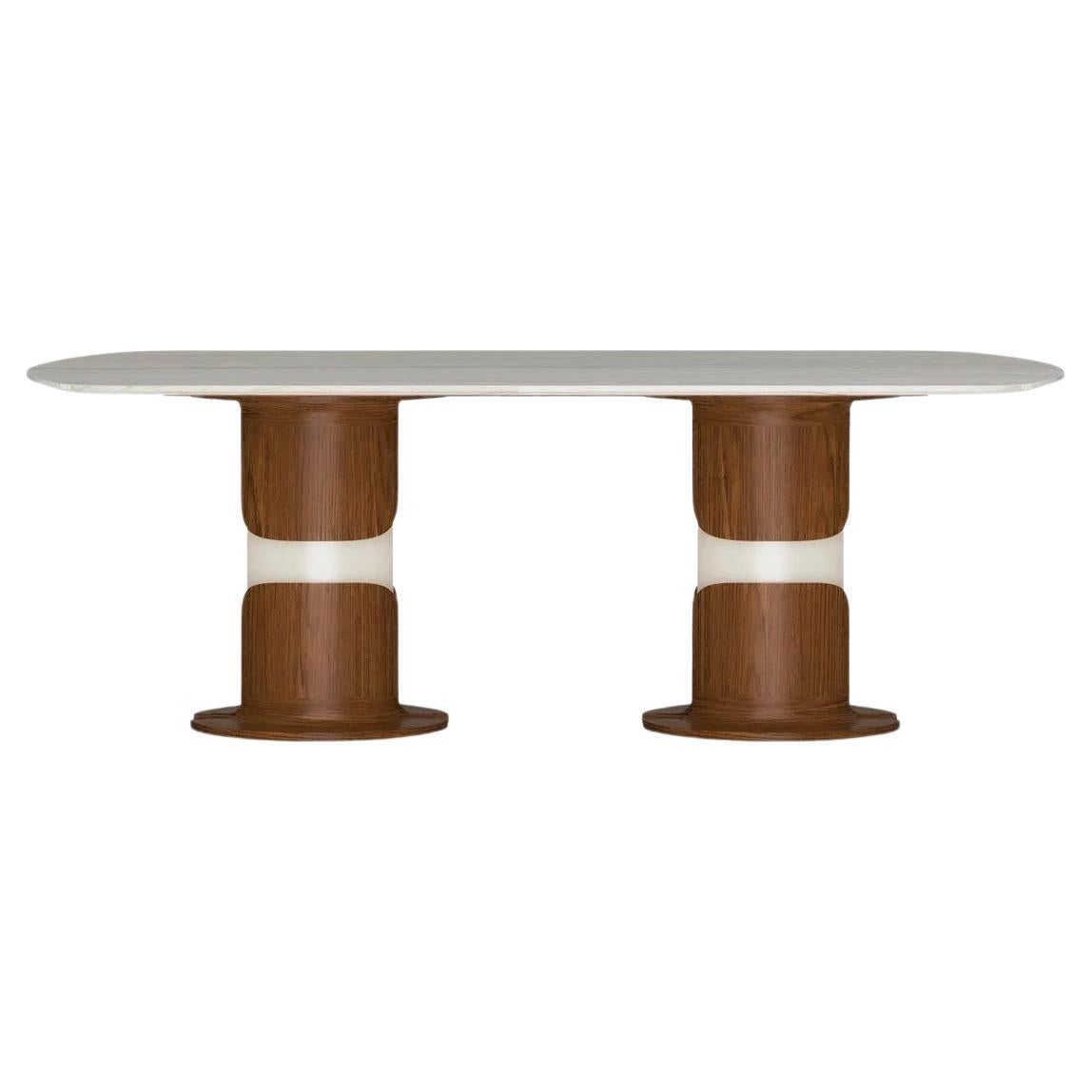 Dogum dining table displays a sculptural and powerful stance. The flower-like form of the legs symbolizes birth. The form of the lower part of the dining table consists of solid walnut, walnut veneer and glossy lacquer on wood. The dining table’s