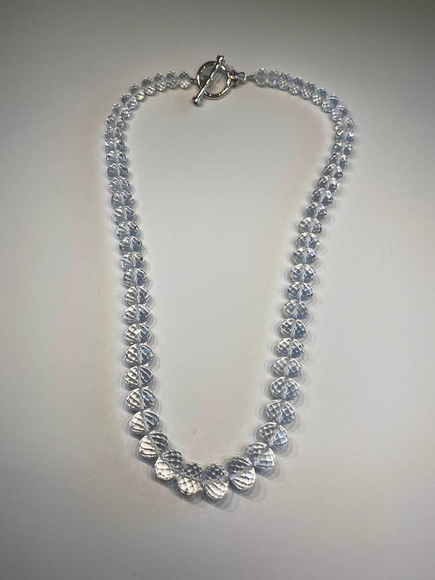 Kary Adam Designed, White Quartz Rondelle Beaded Necklace with a Silver T-Bar Clasp. Clasp is set with lovely delicate Pink Tourmaline Cabochons.

Originally from San Diego, California, Kary Adam lived in the “Gem Capital of the World” - Bangkok,