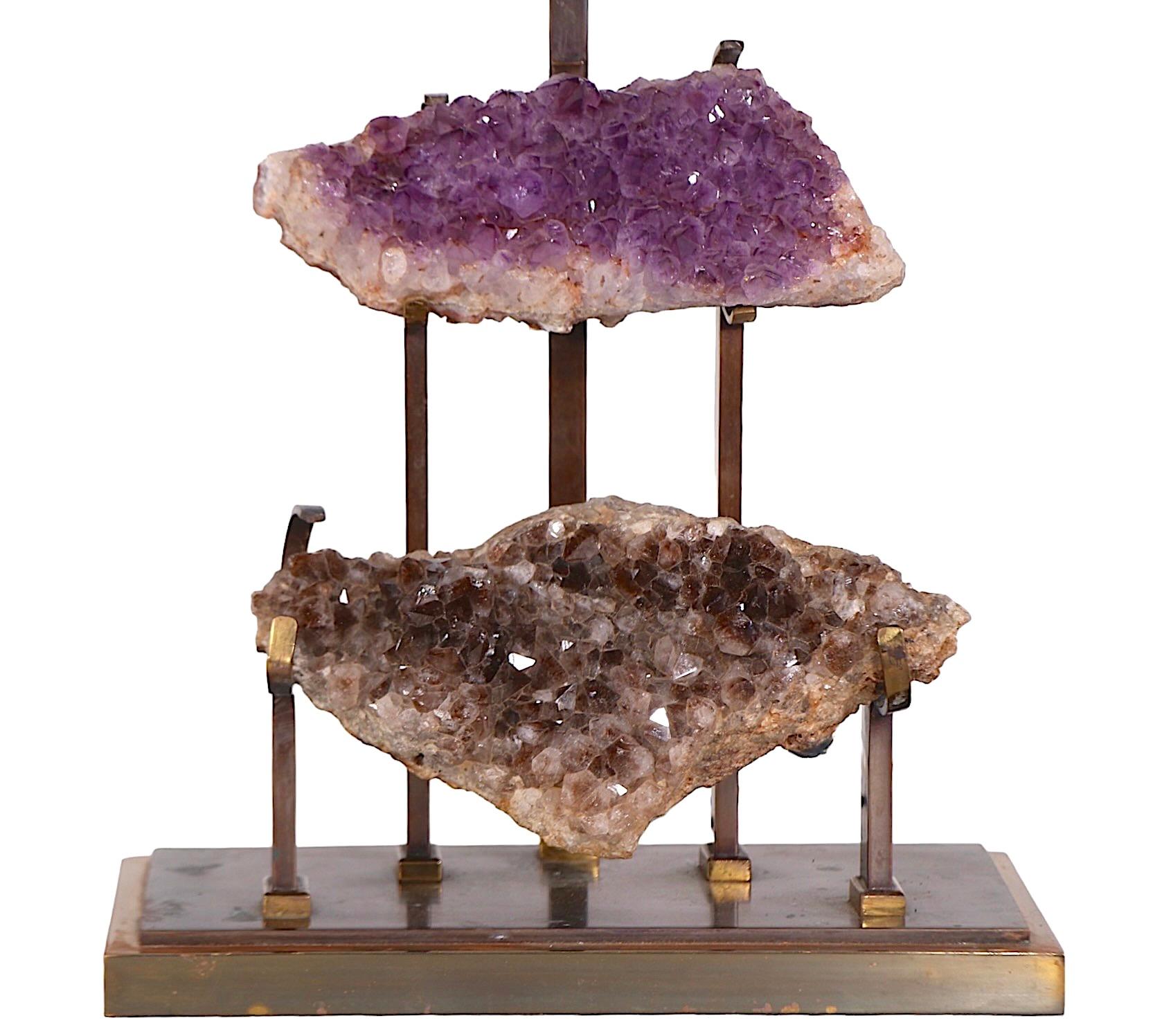 Exceptional table lamp with two quartz specimens mounted in a cast brass frame. The top quartz is a luxurious purple color, while the lower piece is a rich earthy brown tone. The lamp is attributed to Willy Daro or possibly the J.L.B. Lamp Company,