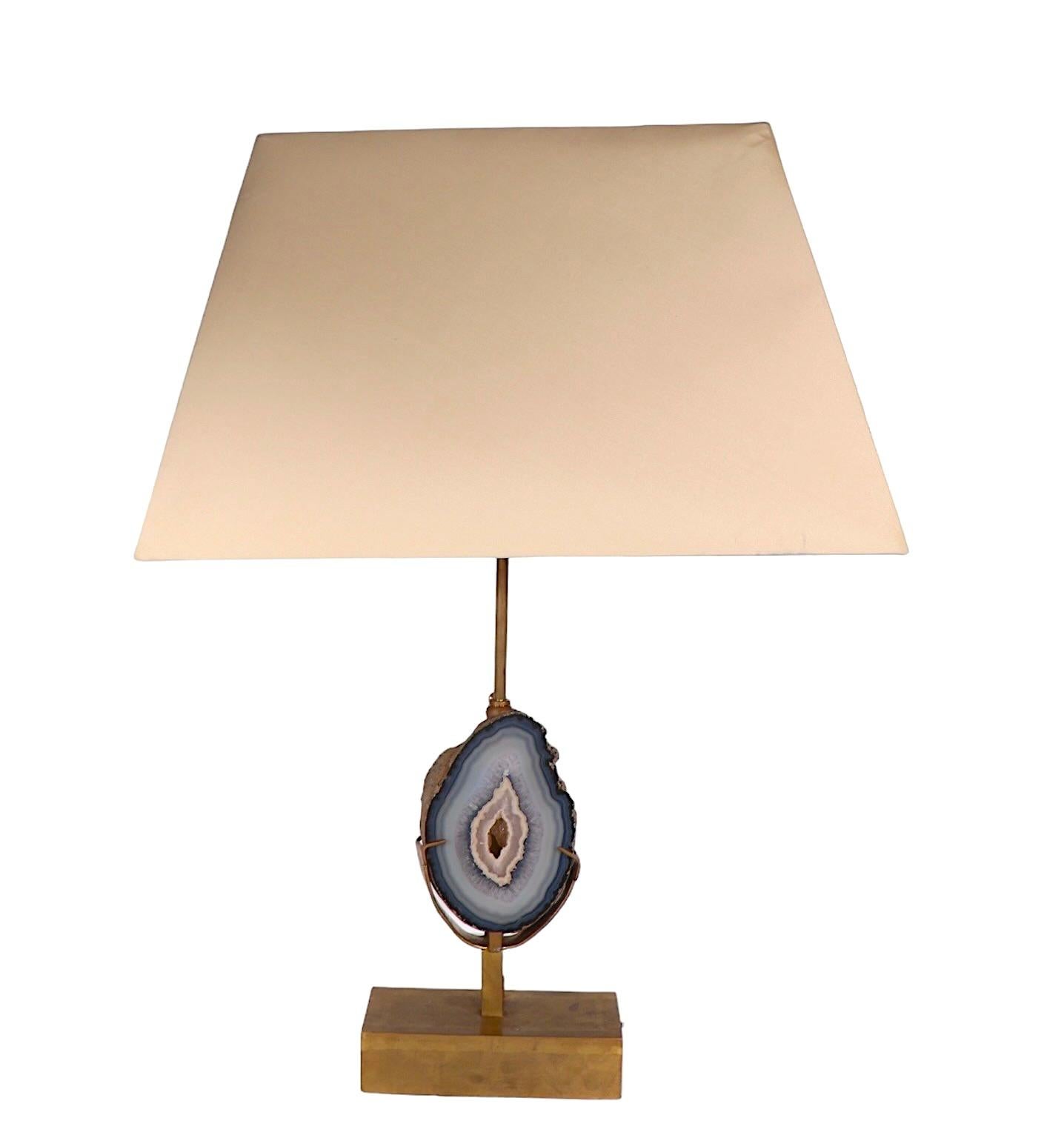 Voguish, chic, and sophisticated specimen table lamp, featuring a polished quartz stone, mounted in a cast brass base. Attributed to Willy Daro, or possibly the J. L. B. Lamp Company, made in either France, or Belgium., circa 1960/70’s, unsigned.