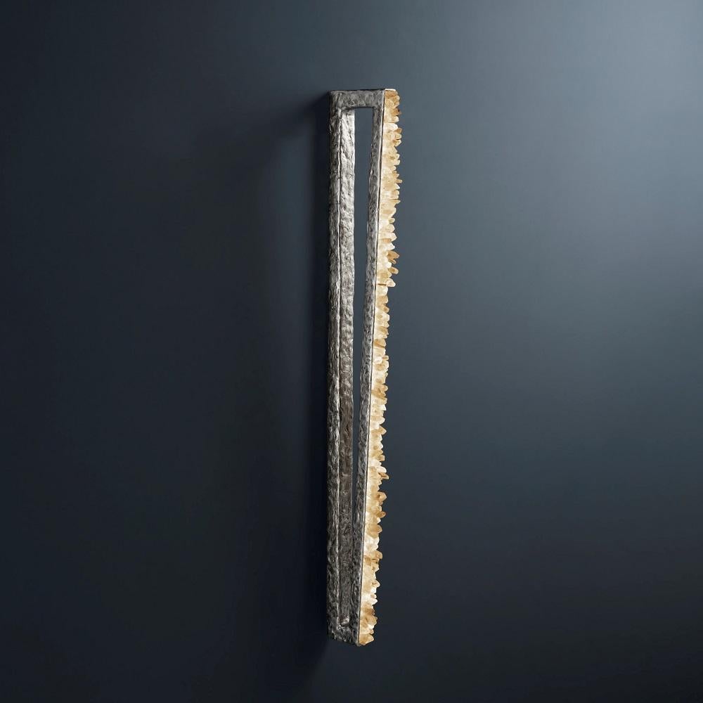Quartz and Bronze Wall Light II by Aver
Dimensions: W 4 x D 18 x H 110 cm
Materials: Natural rocks, high-quality cut crystals, jewelry chains, hand-blown glass, other.
Also available: Matte Black, Rustic Silver, Oxidized Graphite, and Rustic