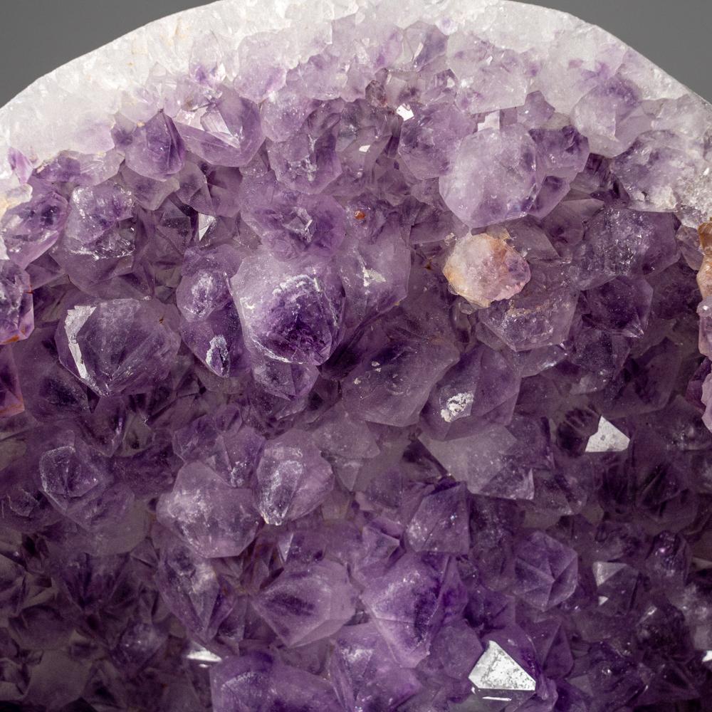 Half of a hollow geode lined on the inner surfaces with lustrous purple amethyst quartz crystals. All of the amethyst crystals are clean and lustrous with medium purple color and are internally transparent.

You will receive the exact object in