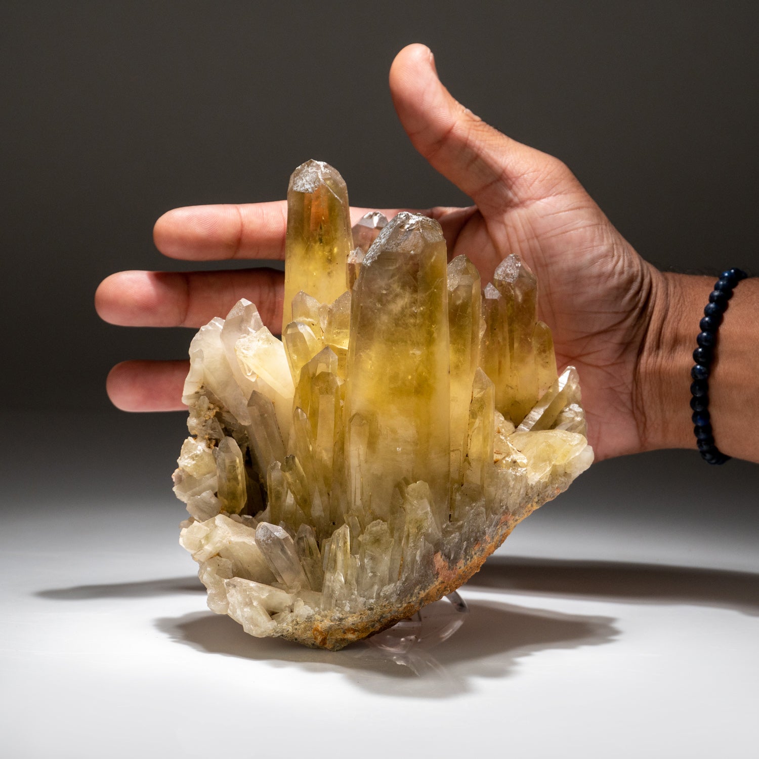 This quartz var. Citrine from Guilin, Guanxi Zhuang, China is a stunning example of the mineral. This specimen features transparent yellow quartz crystals with smoky phantoms at the termination. The quartz is dominated by a single large crystal with
