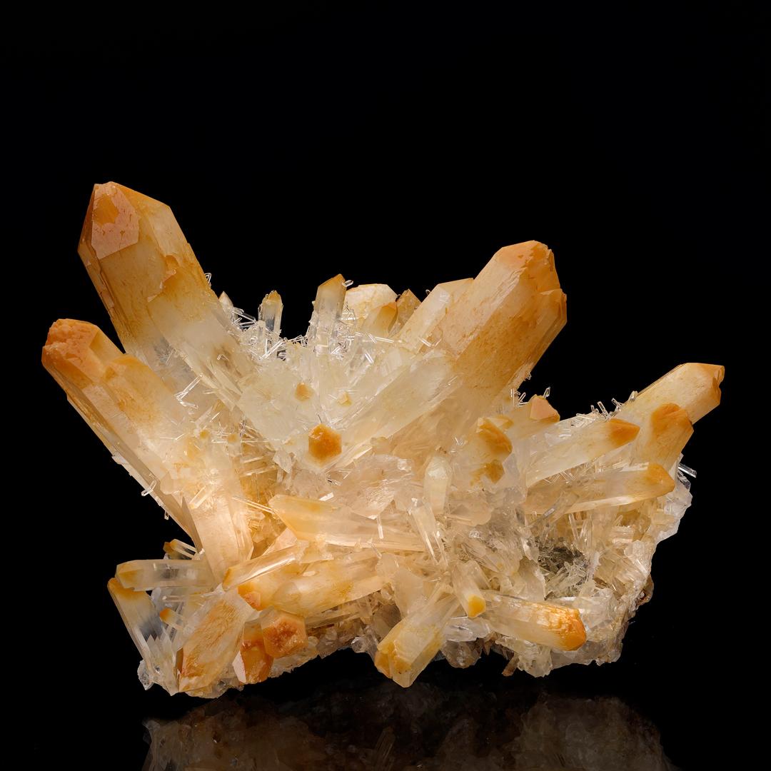 Sometimes known as naturally-occurring mango quartz, quartz with fibrous halloysite inclusions is prized by collectors for the species' naturally unbelievable aesthetics; for its vibrant orange hues juxtaposed against often water-clear colorless