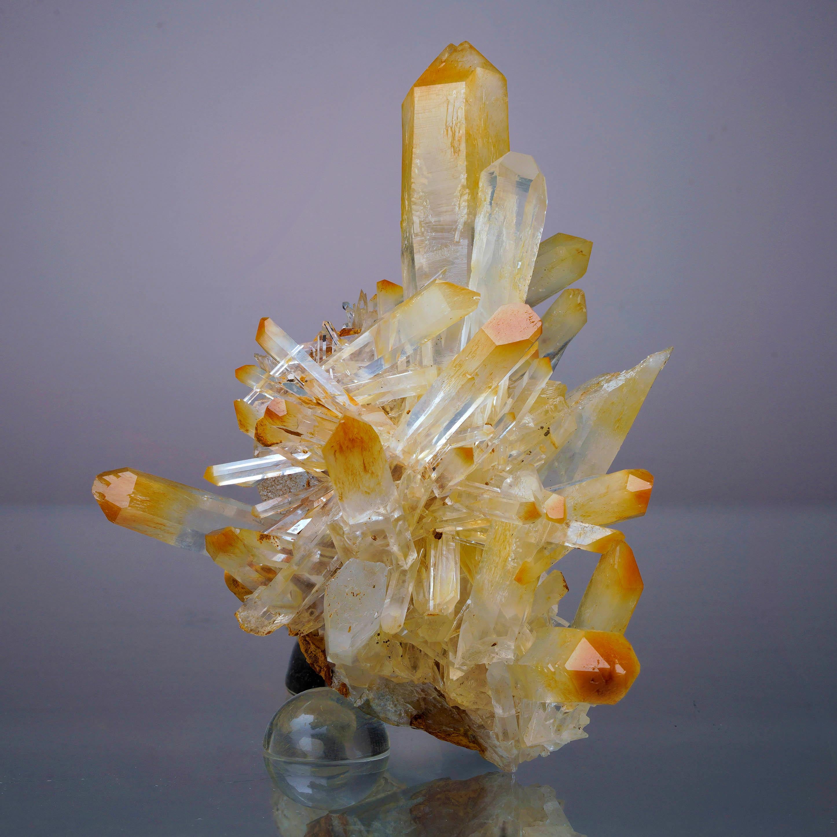 Out of a newer pocket in Colombia and sometimes known as naturally-occurring Mango Quartz, Quartz with fibrous Halloysite inclusions is prized by collectors for its often vibrant orange hues posed against colorless translucency. This energetic