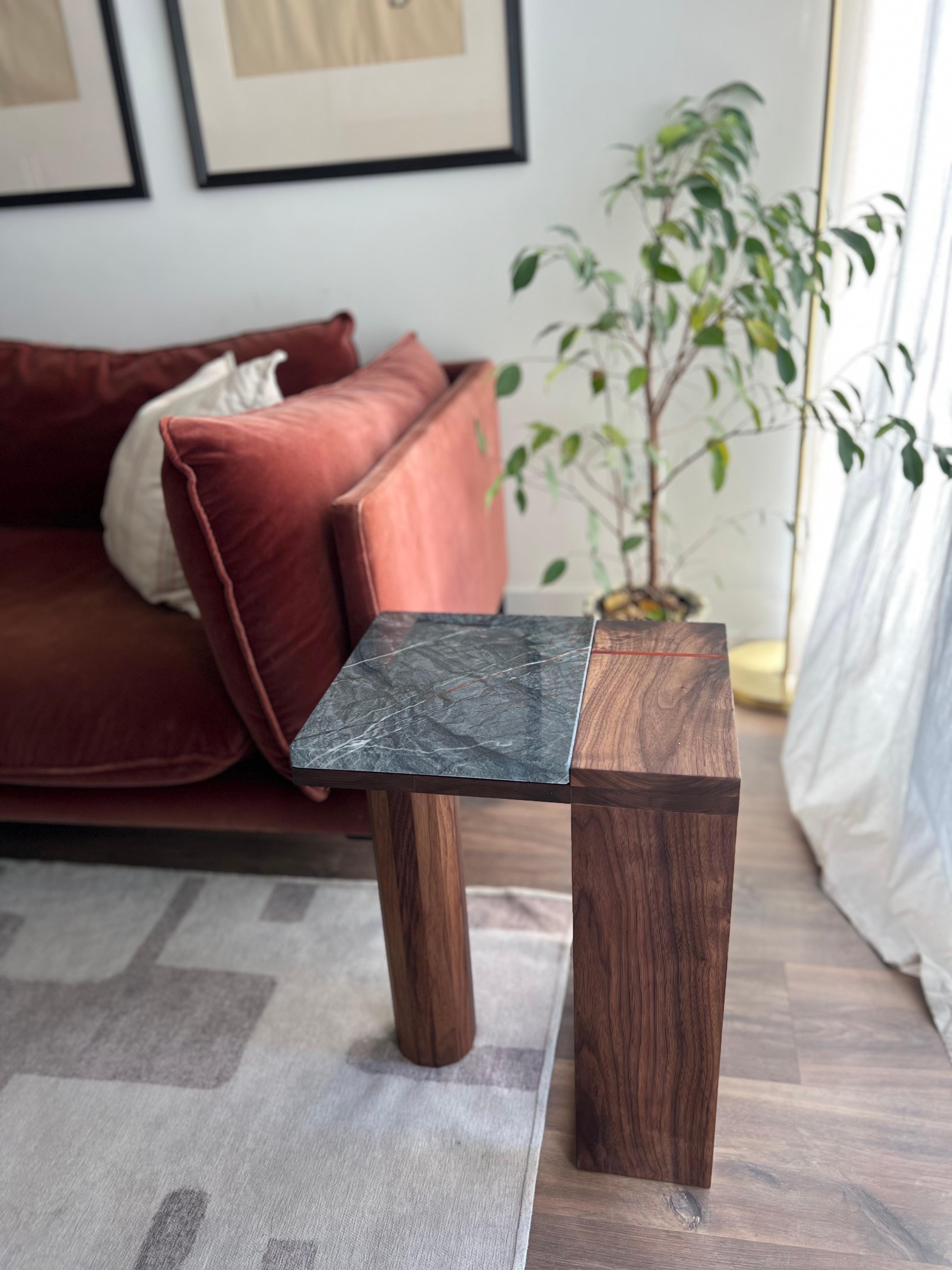 A seamless fusion of nature’s raw beauty and precise craftsmanship, this side table by Redline Designs Collective pairs richly grained walnut with a striking quartzite slab. The stone’s deep charcoal base is laced with bold veins of white and