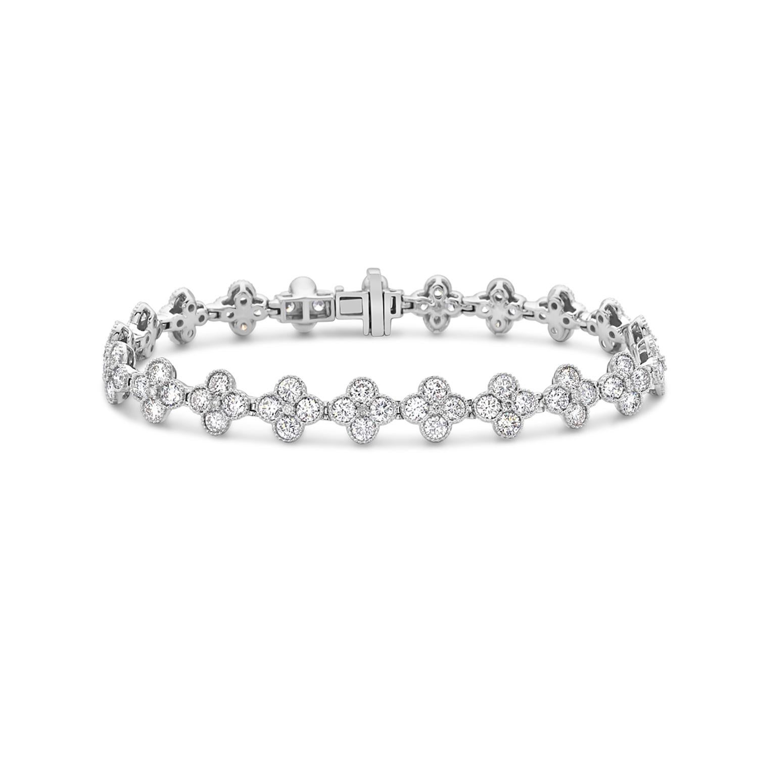 The Quatrefoil Halo Diamond Tennis Bracelet is a stunning piece of jewelry crafted from 18k white gold. It features a quatrefoil design, which is a four-leaf clover shape, encrusted with sparkling diamonds. It is a perfect accessory for any special