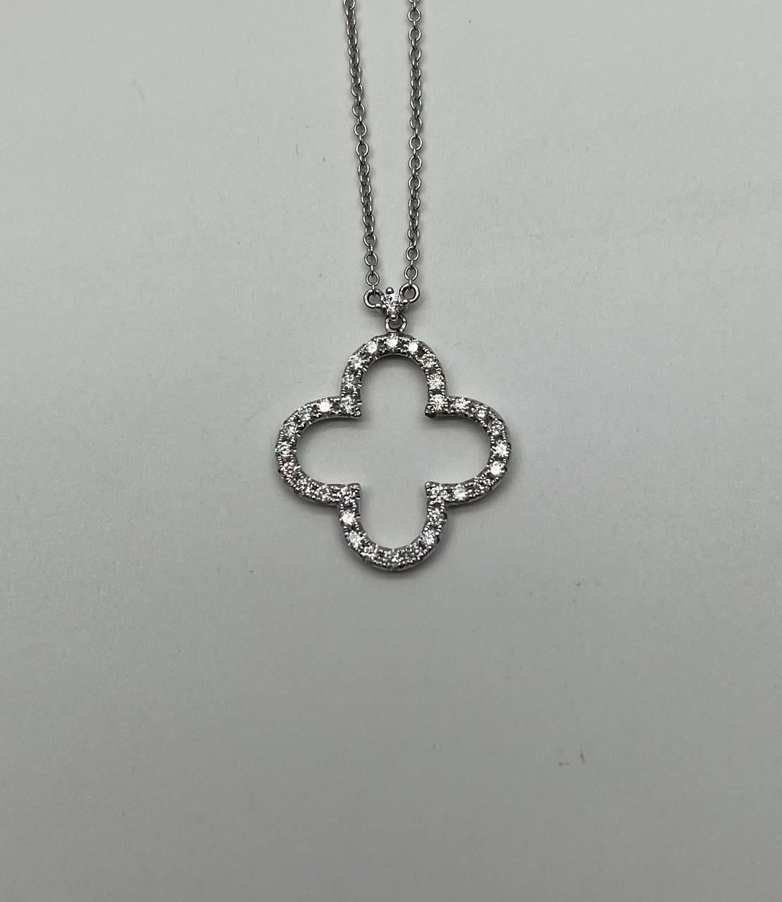This exquisite piece features a delicate clover-shaped design adorned with sparkling diamonds (1.06 CTW), each chosen for its clarity and brilliance. Crafted with precision, the pendant's intricate openwork enhances its sophisticated allure. The