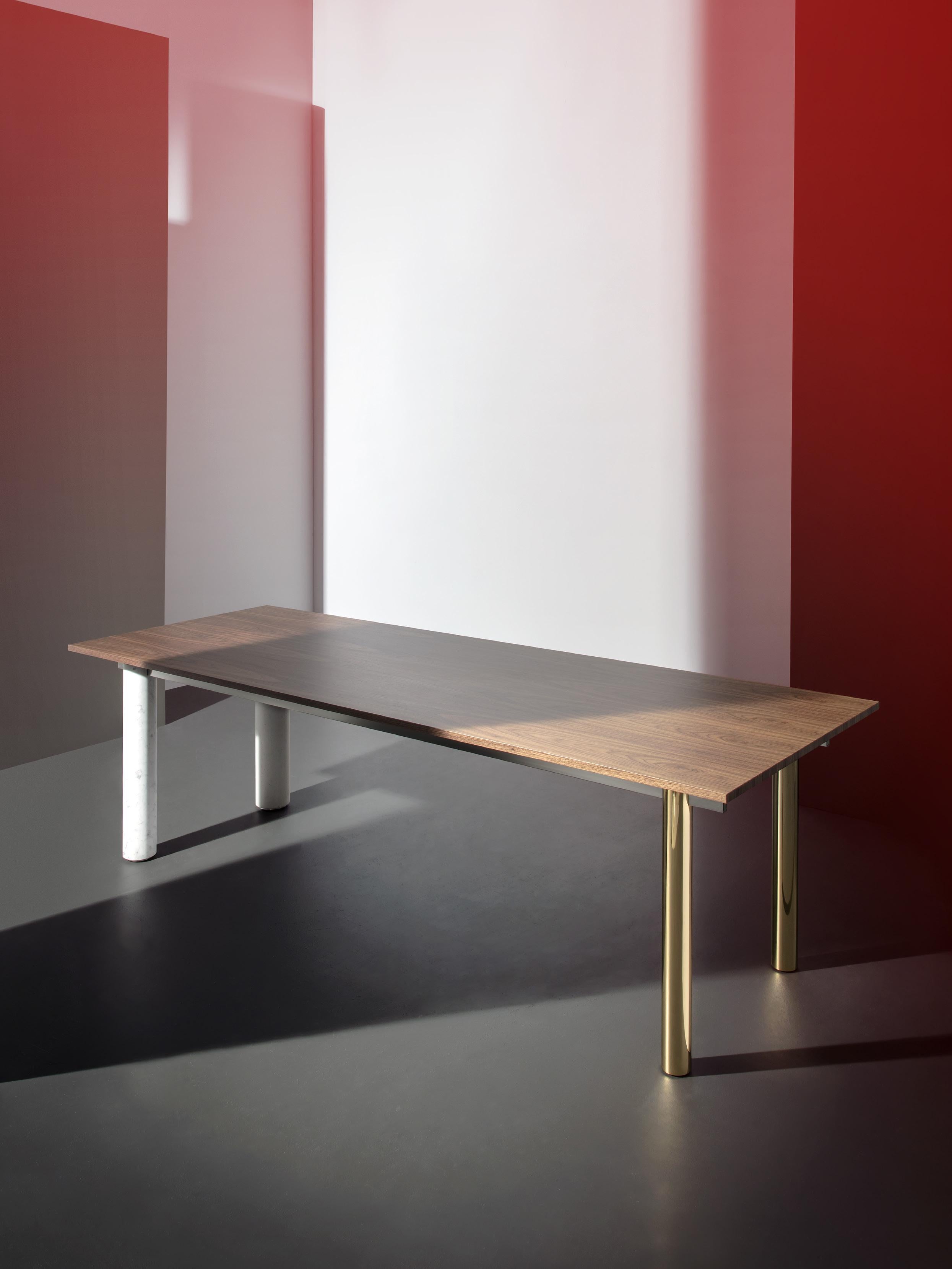 Quattro Gambe is a contemporary table system with its focus on materials. It is a combination of wood, metal, and mineral, customizable at will. The top and the legs can be in walnut, lacquered walnut, marble, metal, or even concrete. This makes