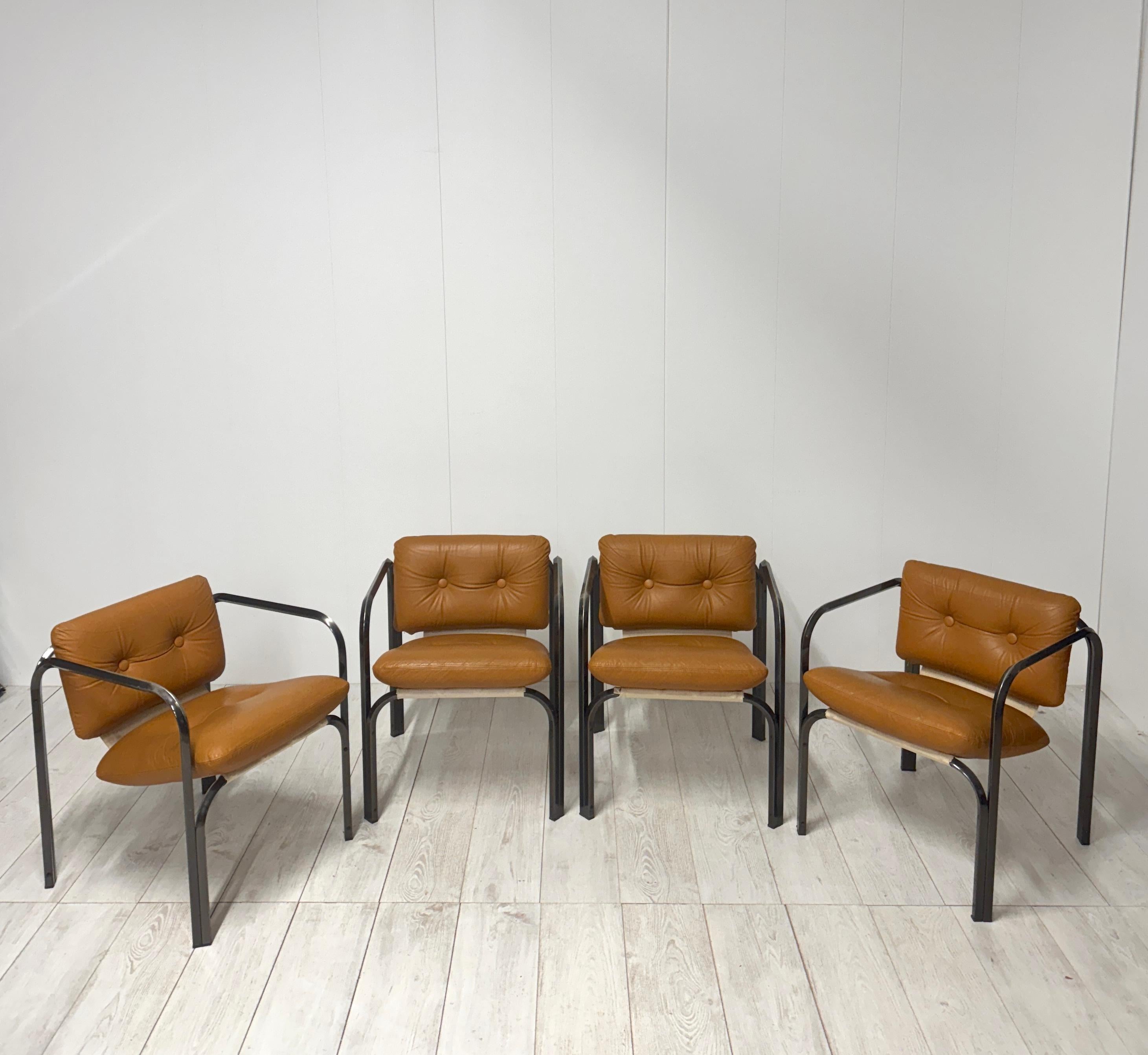 Four chairs made in Italy, 1970s
Steel frame, upholstered seat and back covered in cognac-colored leather
Good overall condition, small marks from use on steel frame.