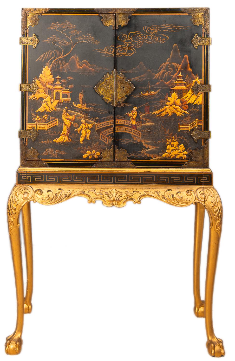 A good quality late 19th century Queen Ann style lacquer cabinet on stand. Have chinosiere
Lacquer decoration with oriental scenes to the two doors, opening to reveal a fitted interior of various drawers, raised on a carved gilded base with ball