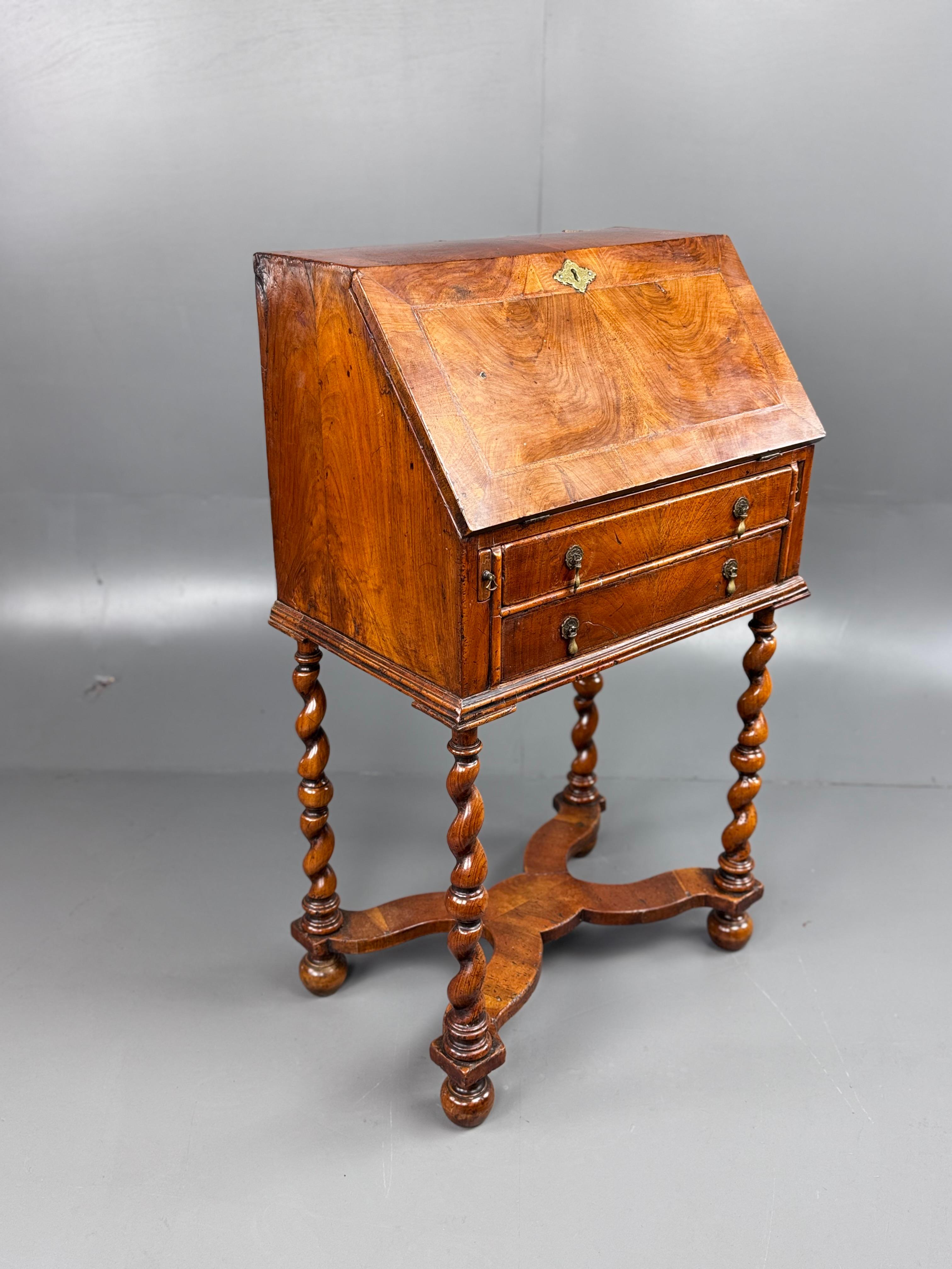 Fine quality small late 19th century Queen Anne revival walnut bureau .
The bureau is a fantastic colour with a good grain . It has a nice fitted interior with four small drawers and cubby holes , It retains its original leather insert to the inside