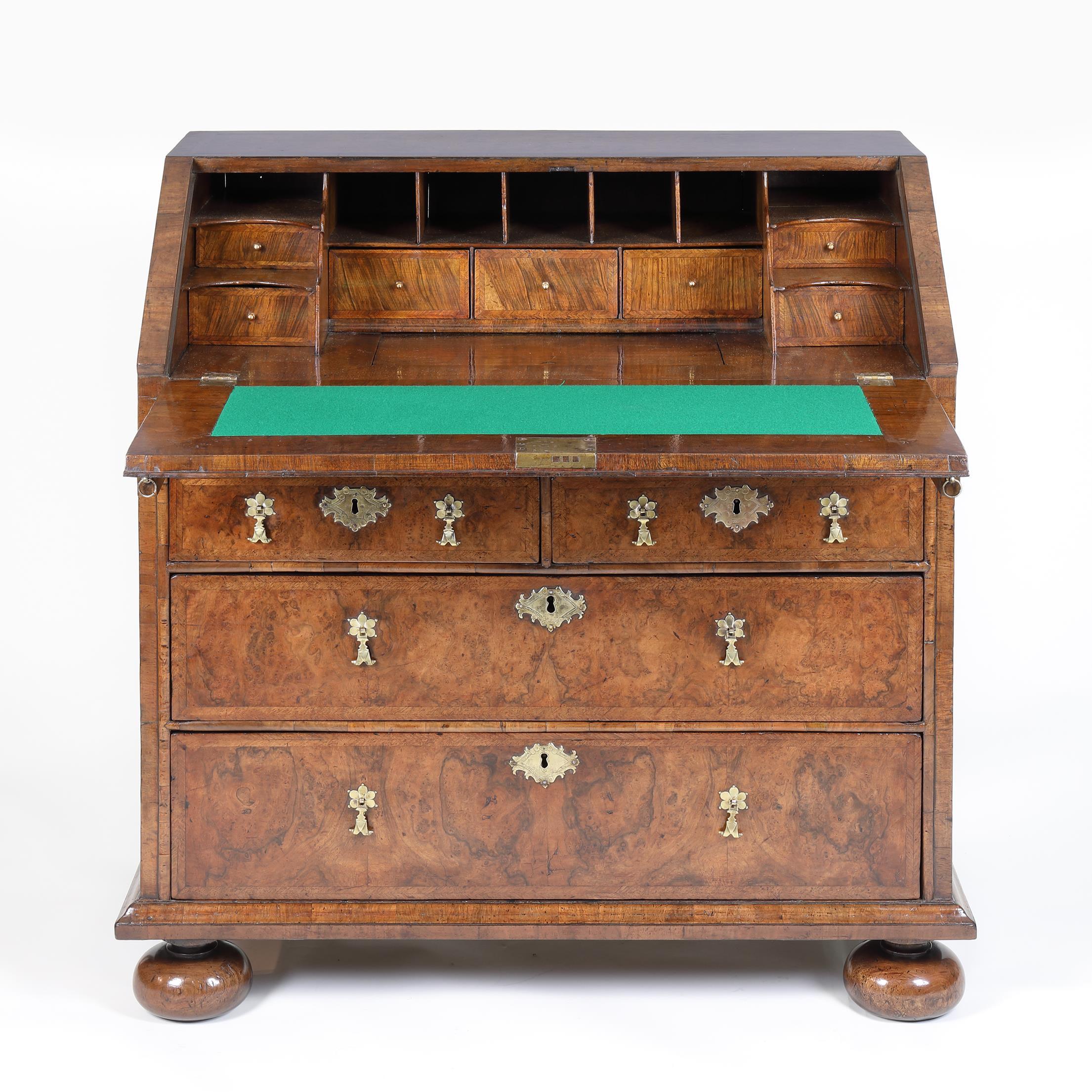 A superior quality Queen Anne period, burr walnut bureau in superb condition and of outstanding colour with curly grain figuring and deep, rich patina. The shallow sloping fall enclosing a well-executed stepped interior with small drawers and