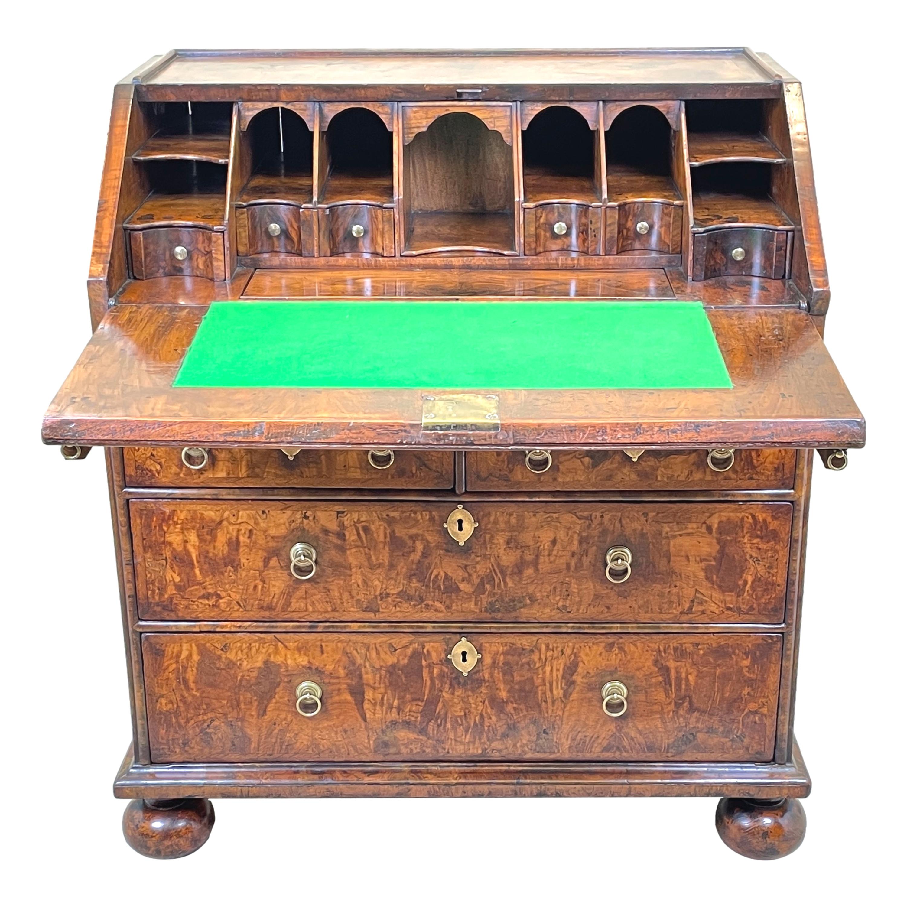 A simply stunning Queen Anne Period Burr walnut Bureau, of exceptional untouched rich colour and patina, with superbly figured veneers to shallow sloping fall, enclosing well fitted interior which includes drawers, Pigeon holes and well with sliding