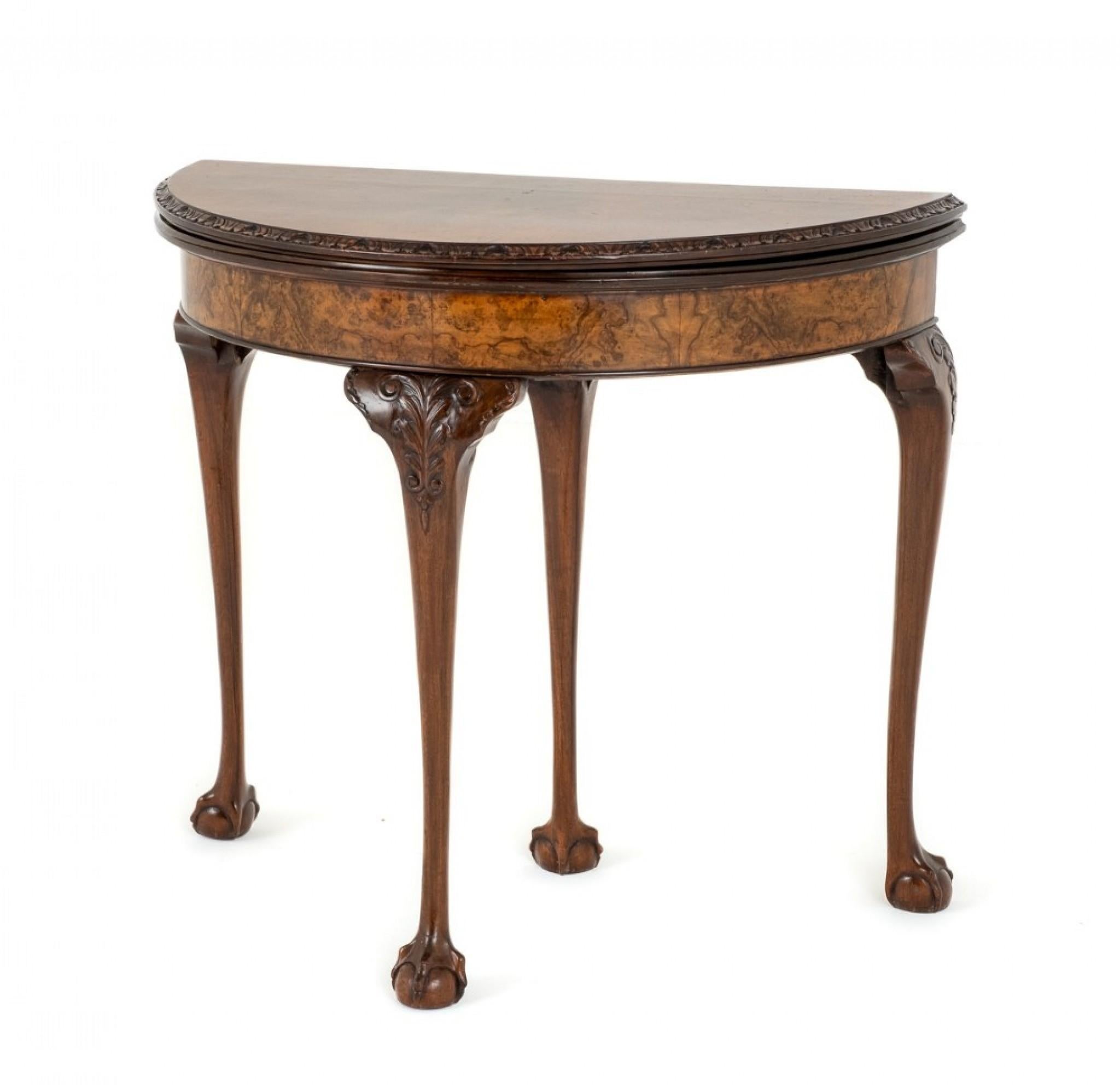 Queen Anne Style Burr walnut Demi Lune Card Table.
This Card Table Stands upon Shaped Legs with Boldy Carved Ball and Claw Feet.
Circa 1920
The Top of The Legs Having Carved Leaves etc.
The Back of the Table Having a Pullout Drawer for ones Cards,