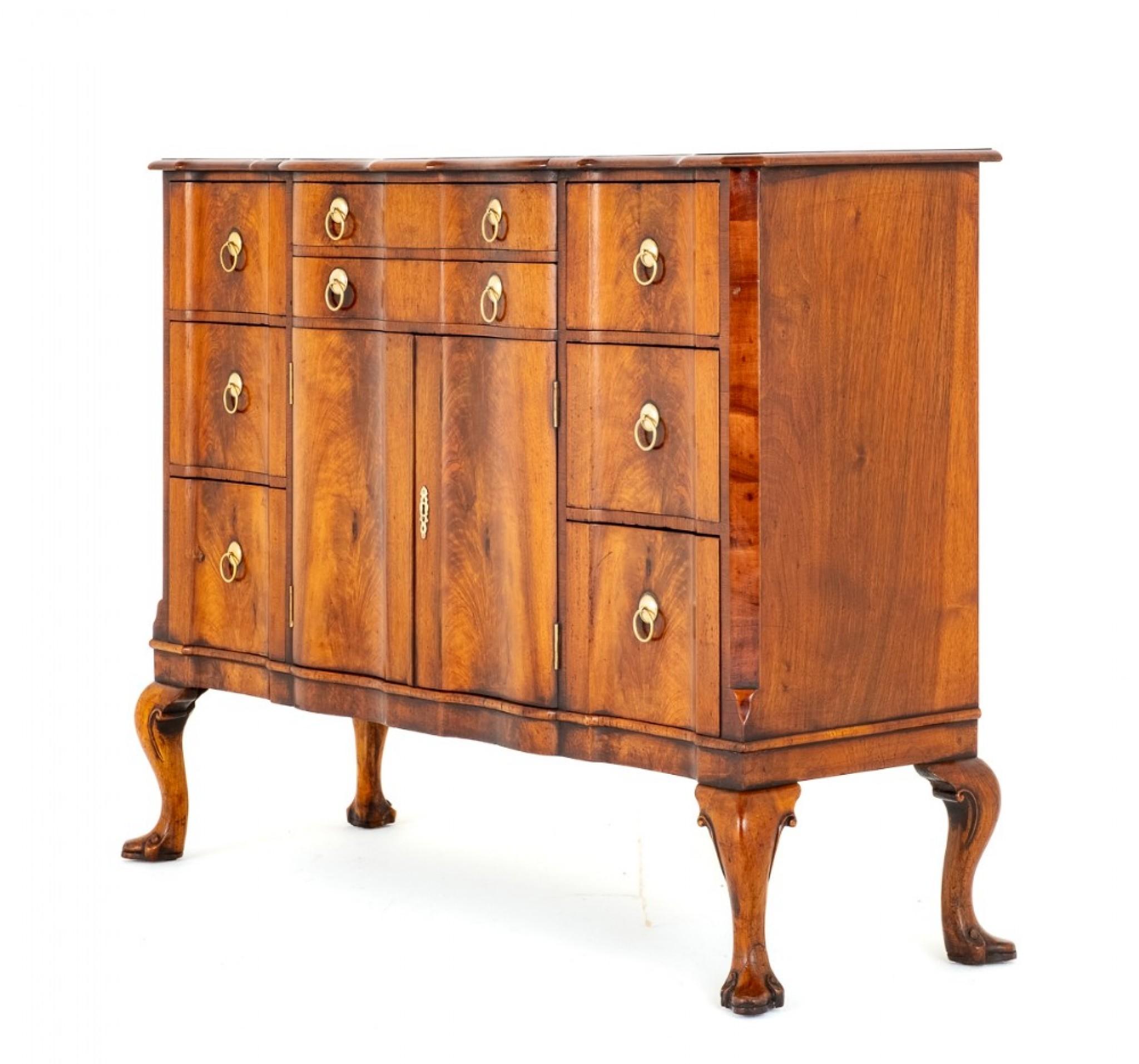 Here we have an Impressive Walnut Side Cabinet.
Standing Upon Cabriole Legs with Carved and Shaped Feet. Circa 1920
The Cabinet Features an Arrangement of 8 Oak Lined Drawers which Feature Period Style Brass Ring Pull Handles.
The Central Doors