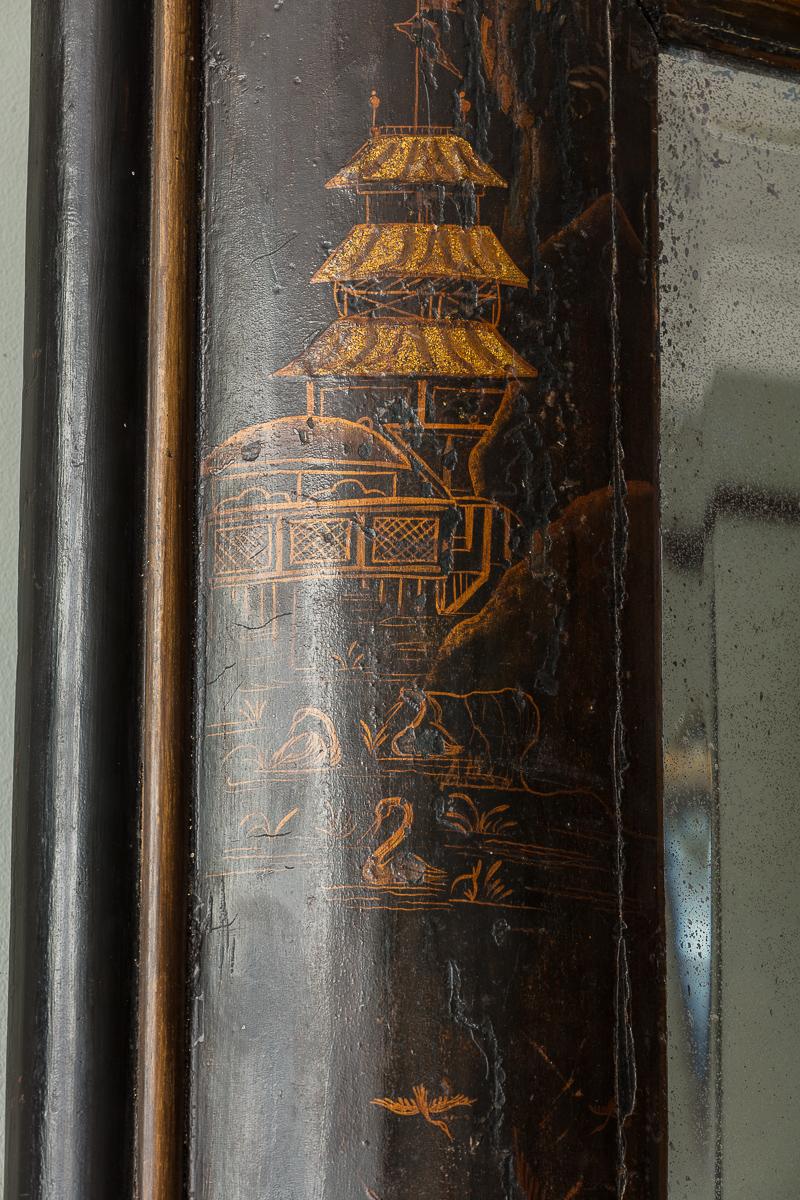 A Queen Anne ‘Cushion Frame’ Lacquer Wall Mirror

Evocative of fine William & Mary and Queen Anne Period wall mirrors, with robustly formed cushion frame with untouched chinoiserie decoration to the black and gilt lacquerwork, with original bevelled
