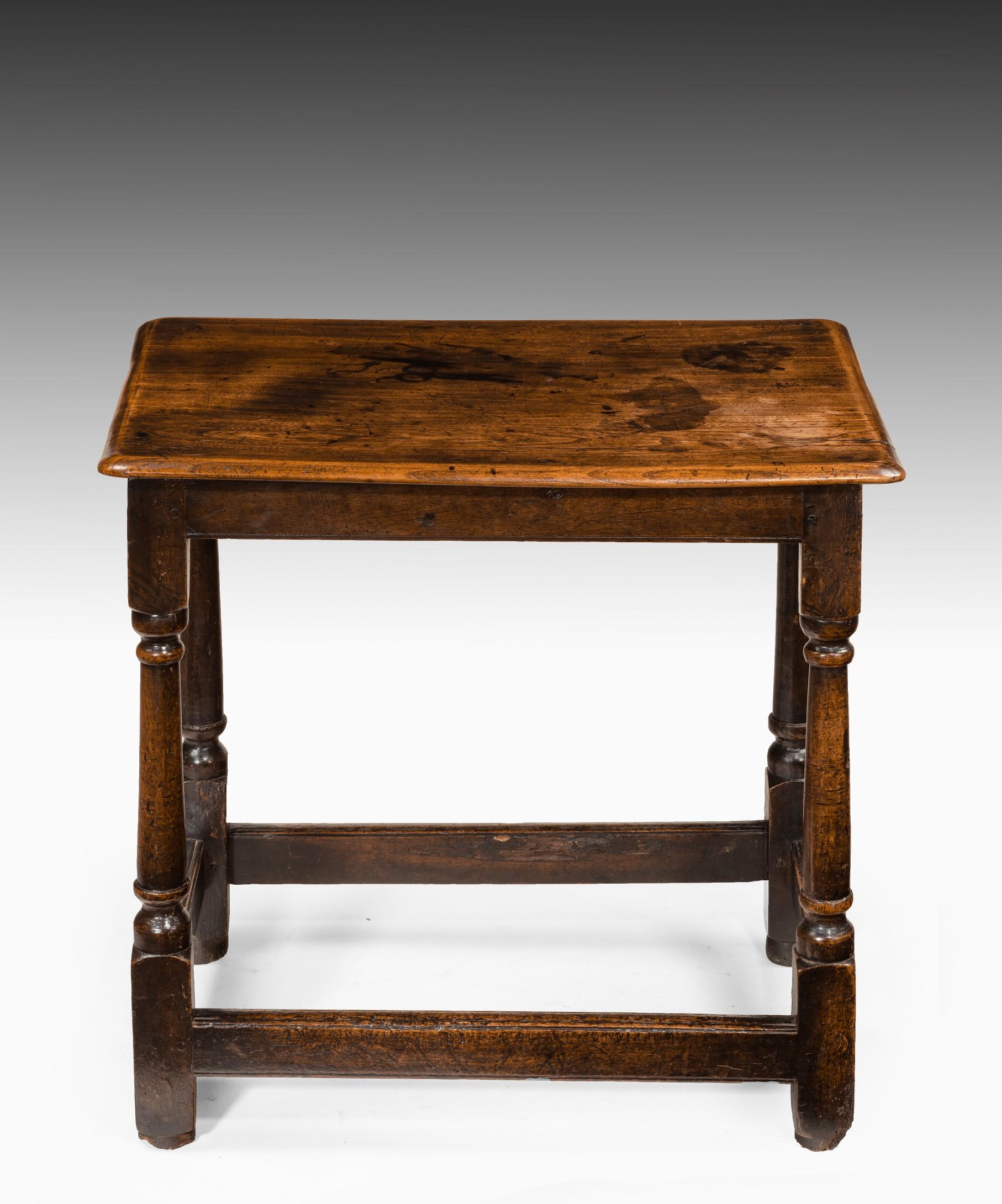 A charming Queen Anne elm side table; the well figured top raised on turned legs united by stretchers and standing on the original turned feet. This side table retains a superb color and patination.

I selected this side table for its fantastic