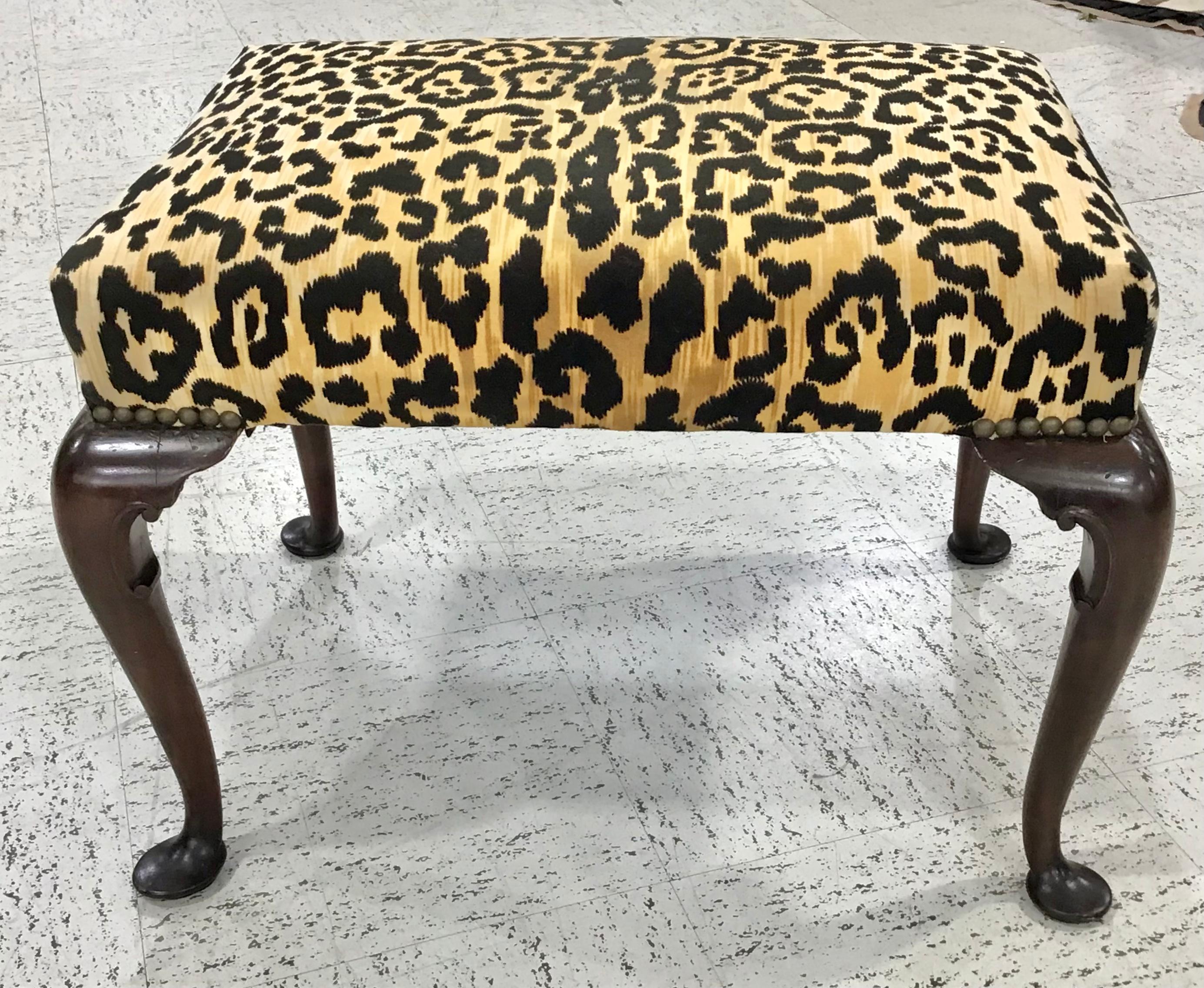 This footstool absolutely appears 18th century, but is a later, mid-19th century example, as these were quite popular and made through the century. The mahogany is outstanding and has an old wax surface. The tiger print upholstery is in excellent
