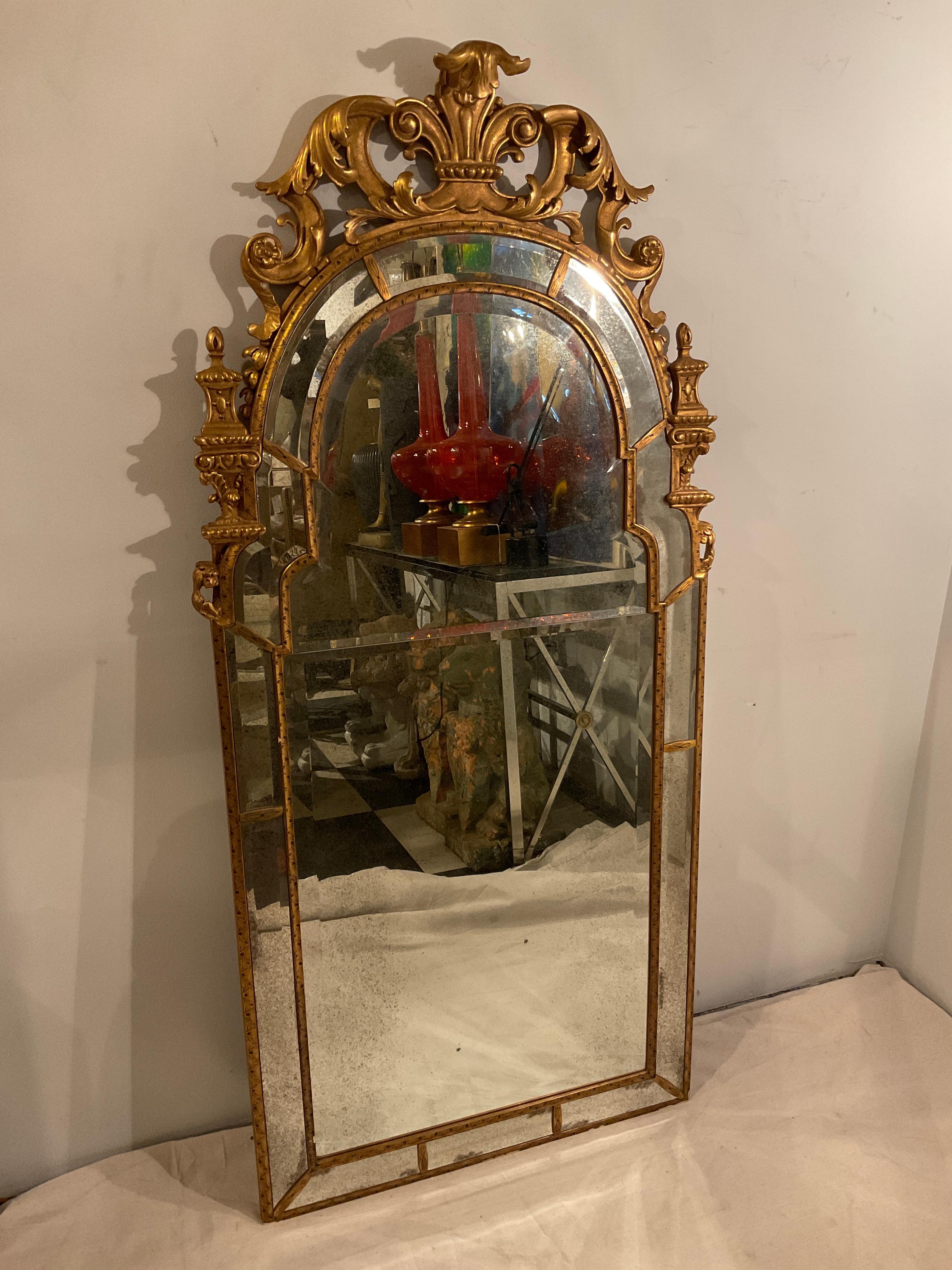 Mirror Fair reproduced this mirror that hangs in Chillingham Castle in England. The original is from 1700. Hand carved, gilt wood with painted details . Each piece of glass is beveled antiqued mirror. It’s a stunning mirror.