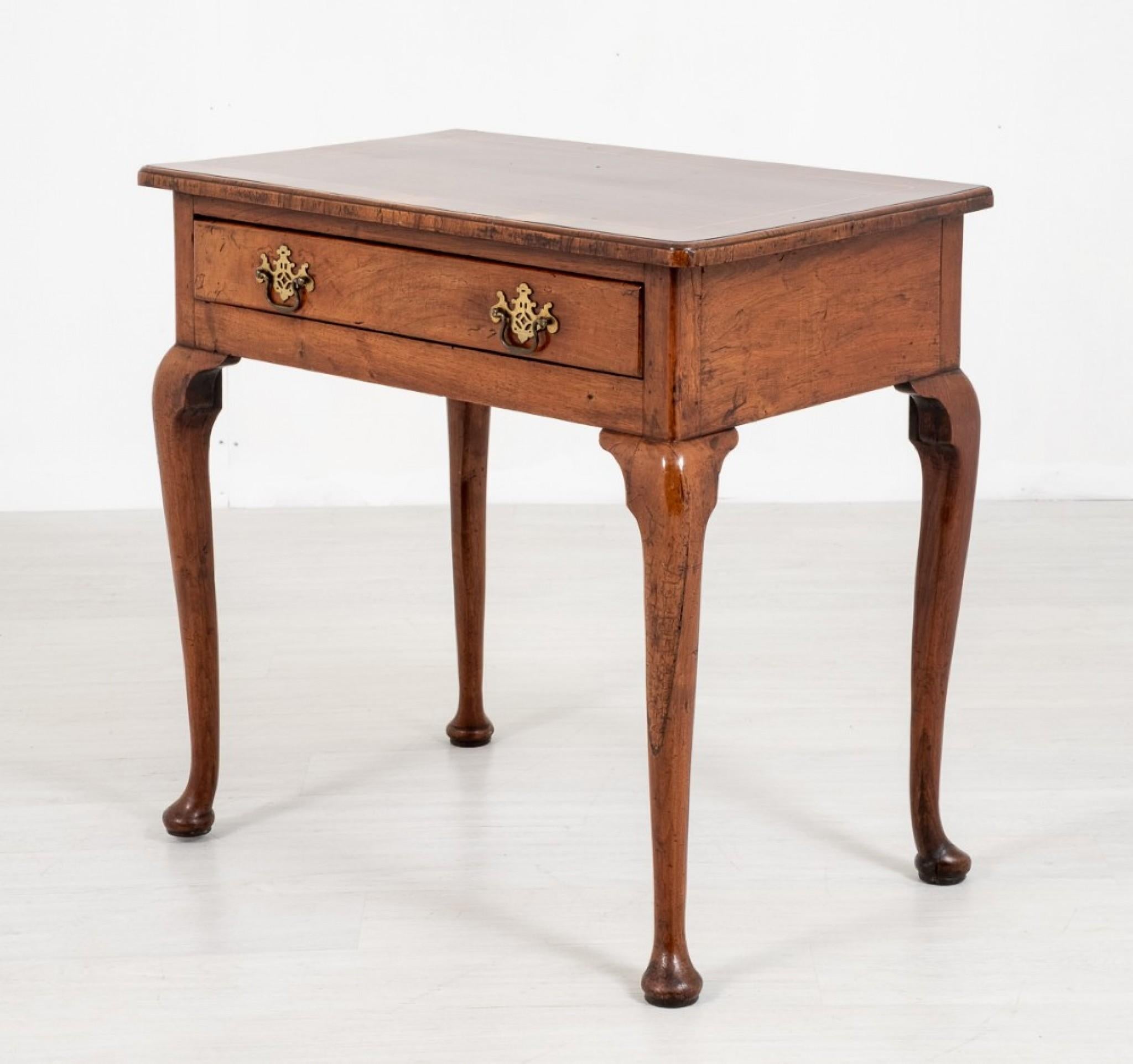 Queen Anne Style Mahogany LowBoy.
Standing upon typical Cabriole Legs with Pad Feet.
18th Century
Having a Single Drawer with Pierced Plate Handles.
The top of the LowBoy having Crossbandings, Holly line inlays and Crossgrain Mouldings.