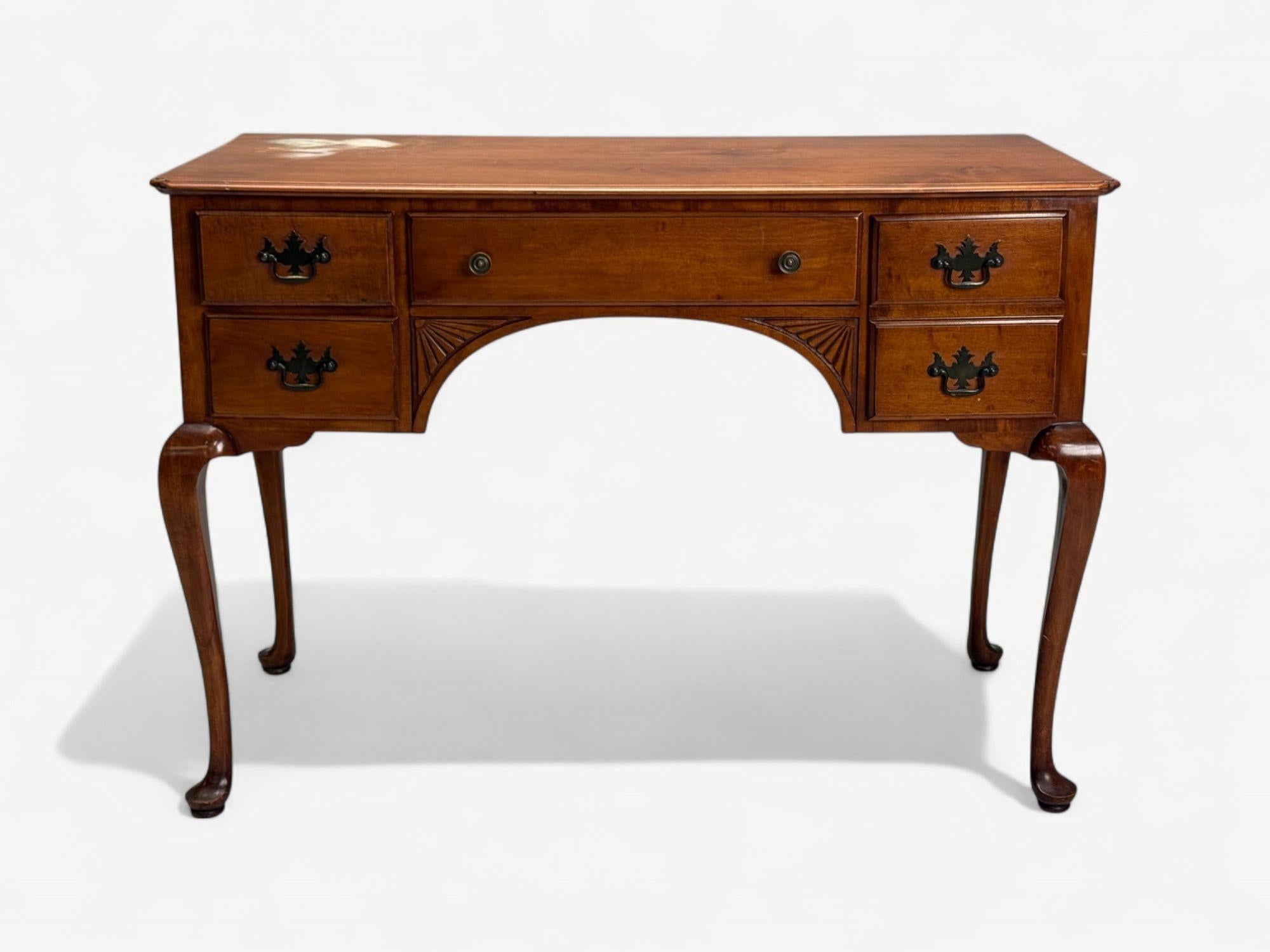 Queen Anne, Mahogany, Brass, Writing Table or Desk, England, 1900s

A Queen Anne style mahogany and brass writing desk designed and produced in late 19th/early 20th century England. This example features an overall Georgian form, five pull out