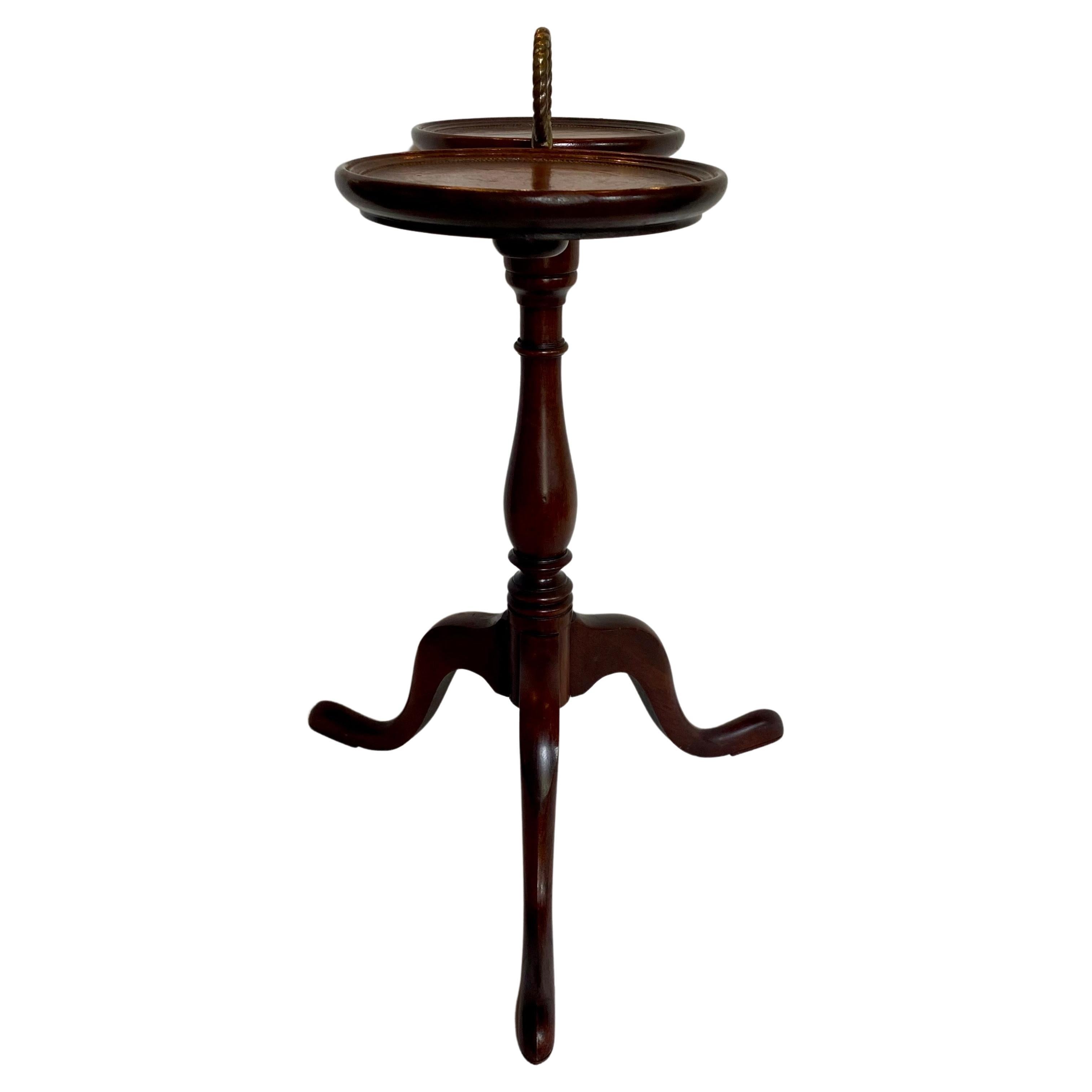 Mahogany double pedestal side accent table by Brandt Furniture Company. Two round tooled brown leather tops sit atop three Queen Ann shaped legs. The perfect sized drinks or martini spot table for next to a chair or sofa. Original manufactures label