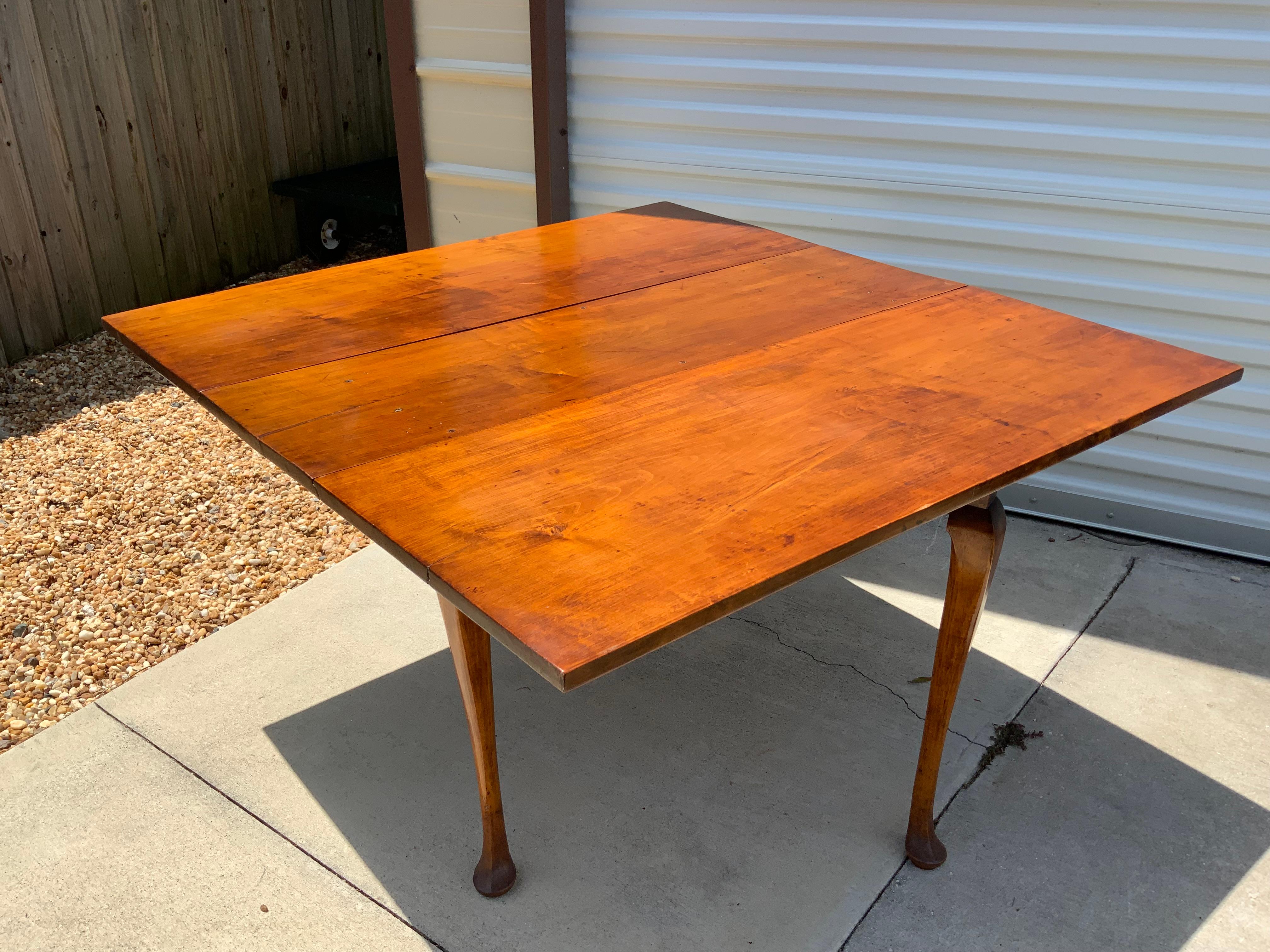 Very nice 18th century Maple drop leaf table New England 1740-50. Excellent color and patina on a very old refinish. All pegged base and top. Completely original. Nicely carved pad feet.  Measures 43 x 46 with both leaves up.