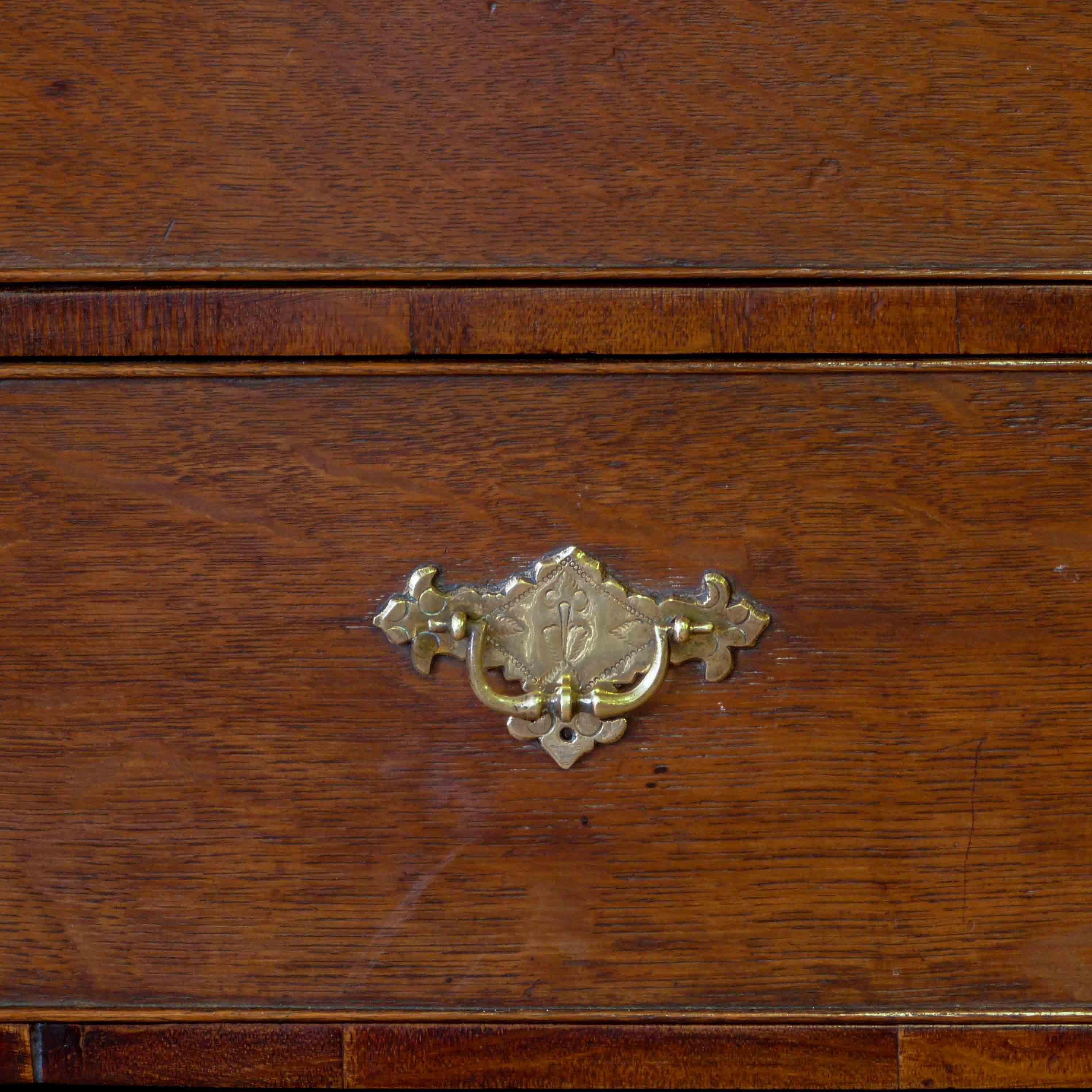 An early 18th century oak chest on stand from the Queen Anne period. In overall good original condition with signs of long deceased woodworm in the feet and on the top boards (retreated by us as a precaution). Some of the stretchers could have been